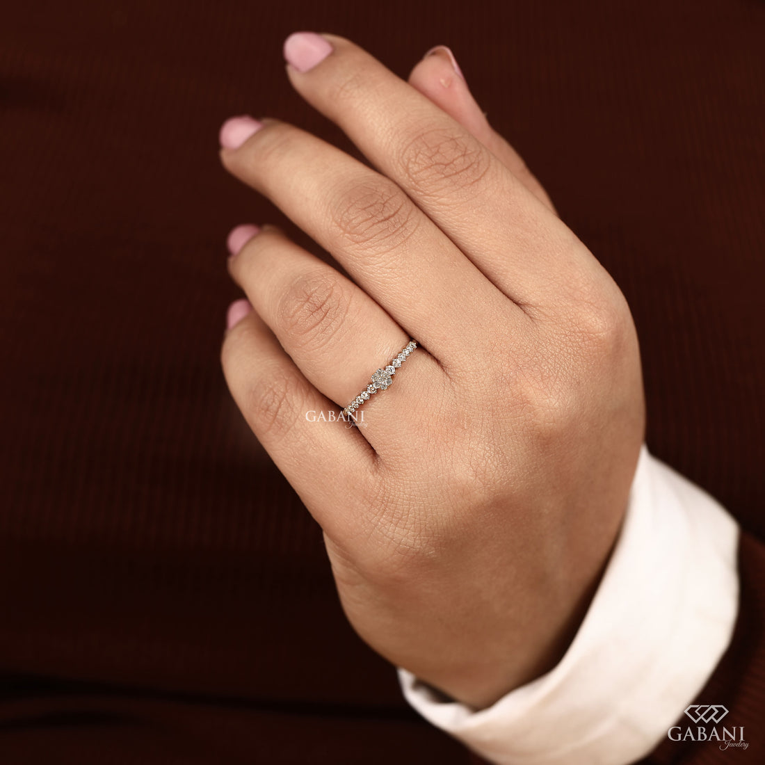 Round lab grown diamond floral cluster wedding band in white gold with graduated side diamonds and prong setting.