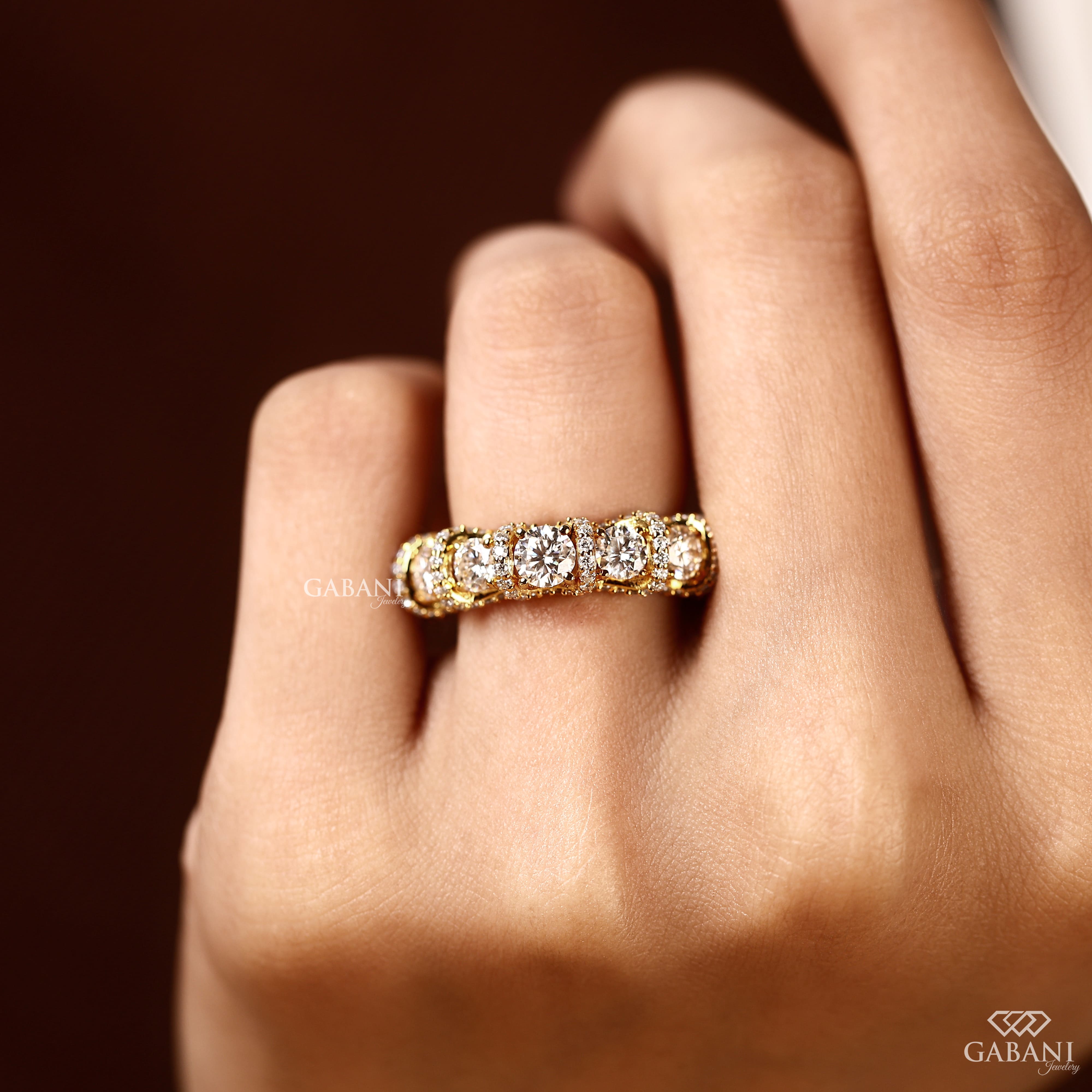 Five stone round cut lab grown diamond wedding band in yellow gold with diamond accent setting, designed for bridal, anniversary and stackable wear.