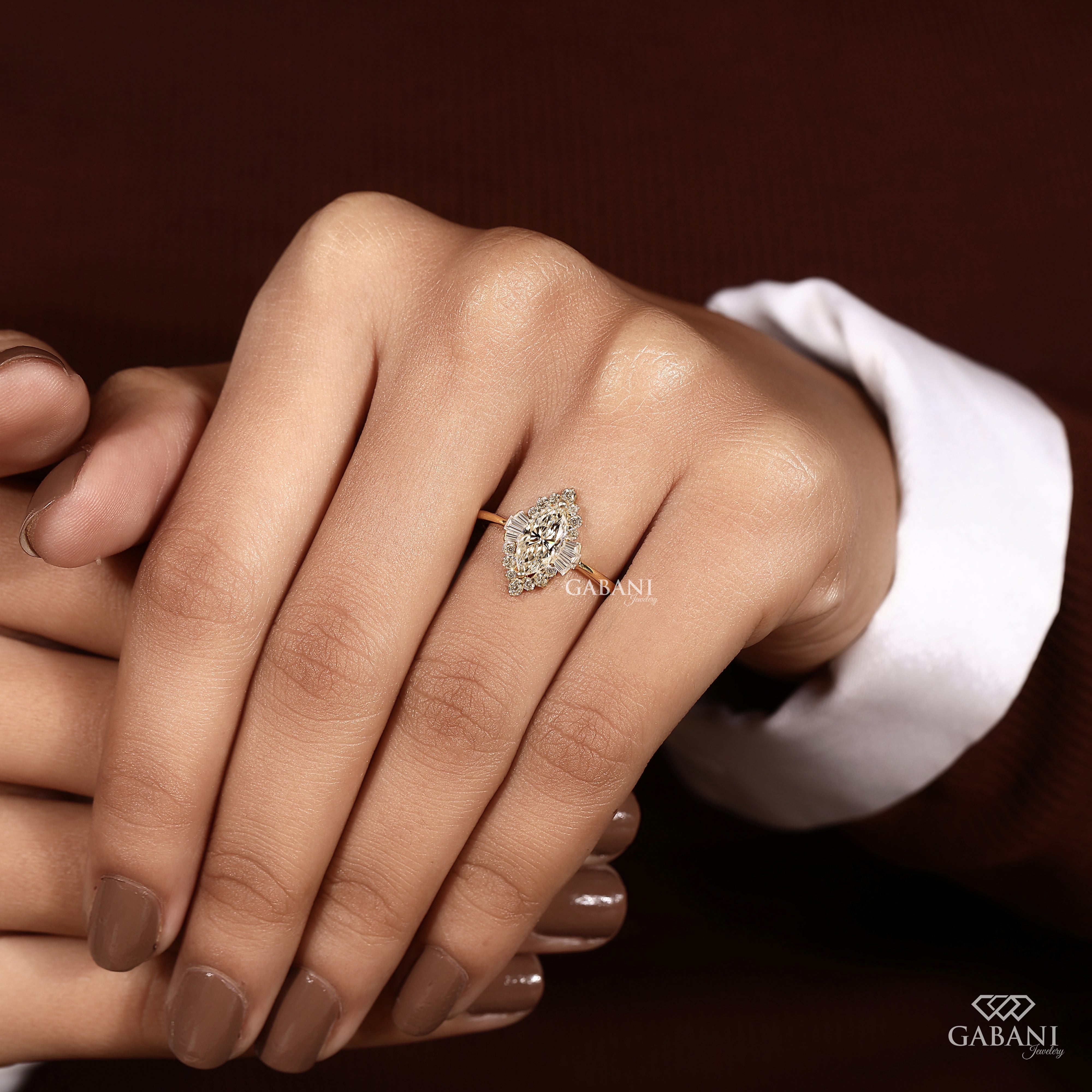 Marquise lab grown diamond engagement ring with floral halo, baguette side stones and yellow gold band, IGI certified EF color VS1 clarity.