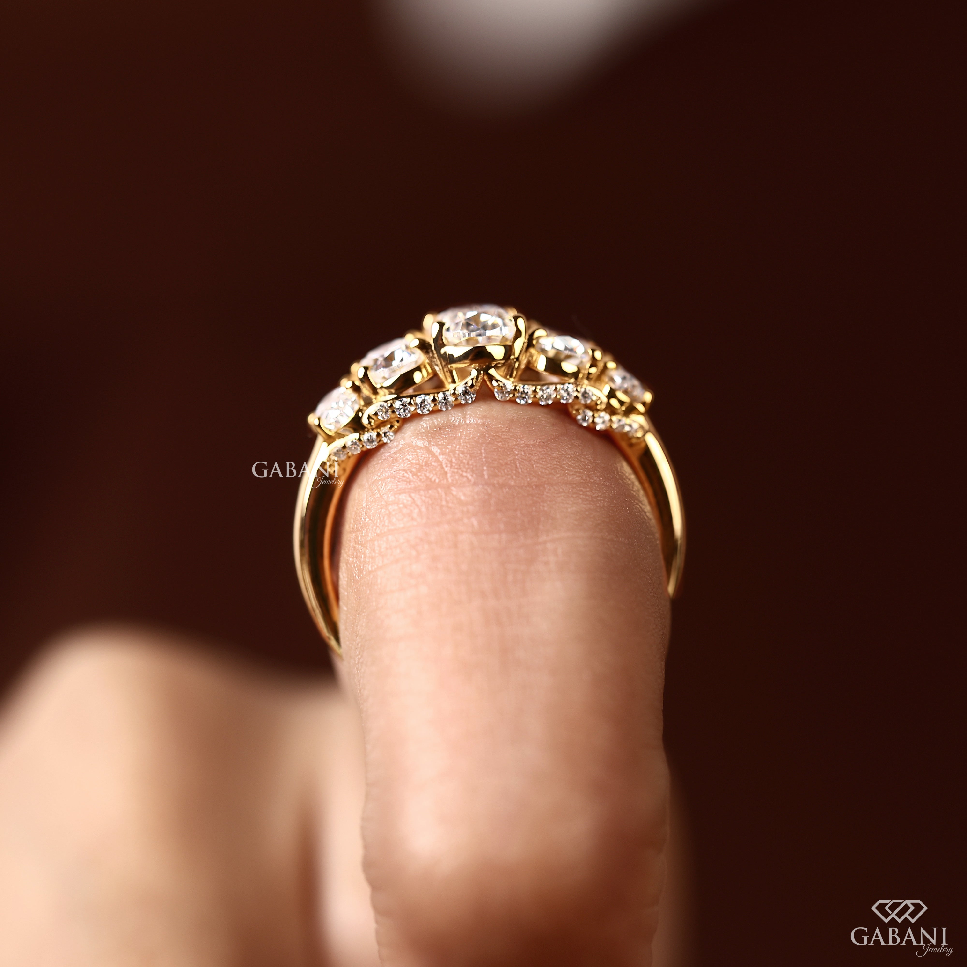 Graduated oval cut diamond ring with lab grown diamond stones