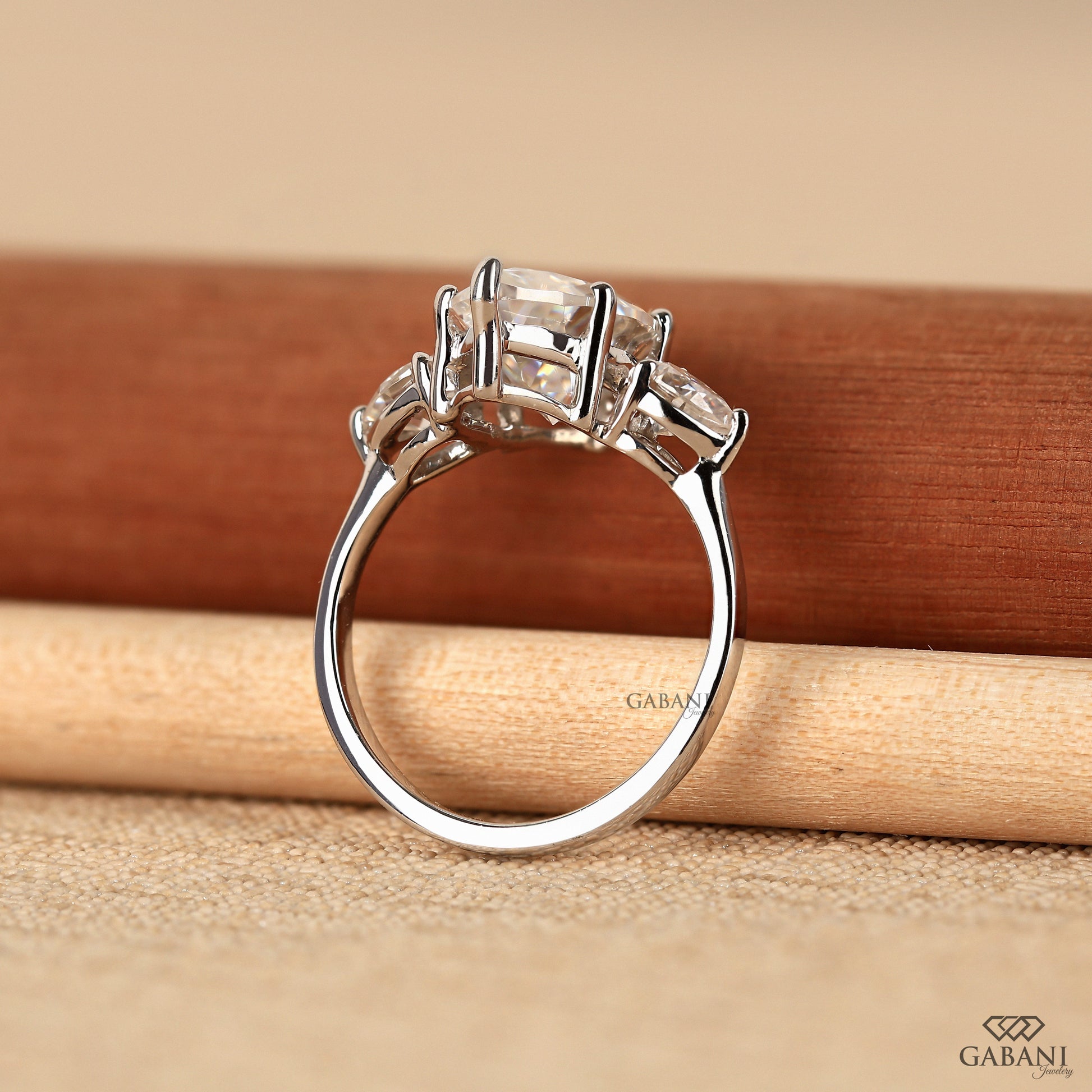 Marquise and pear cut lab grown diamond ring designed as a timeless three stone engagement style