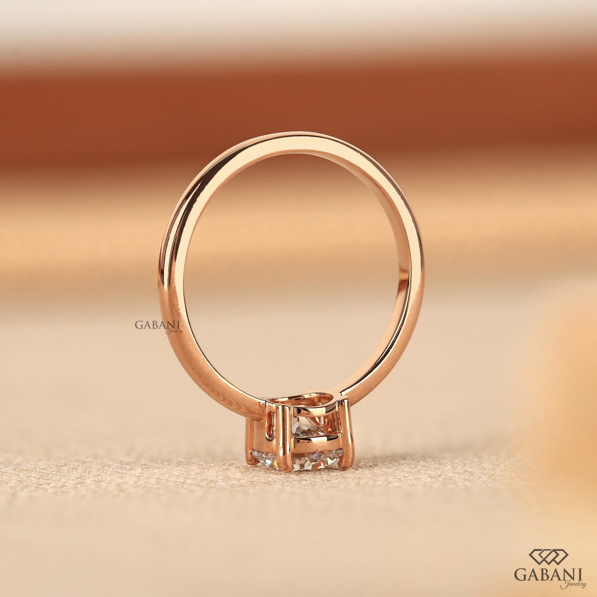 slim rose gold band holding round lab grown diamond solitaire setting