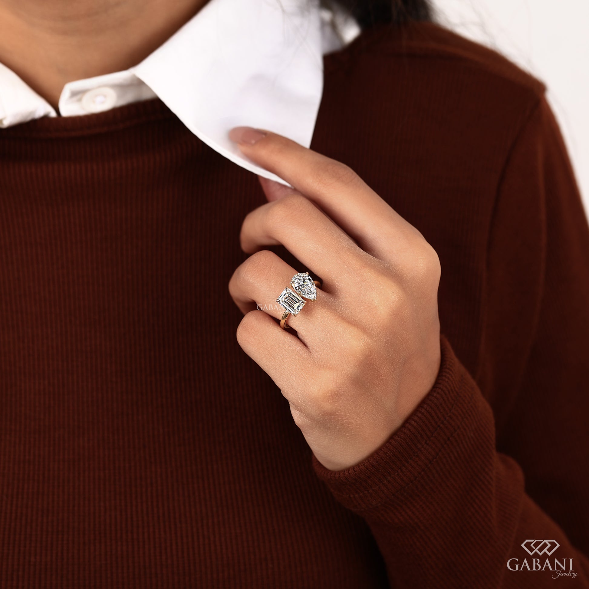 Lab grown diamond you and me ring with emerald and pear cuts set side by side in solid yellow gold