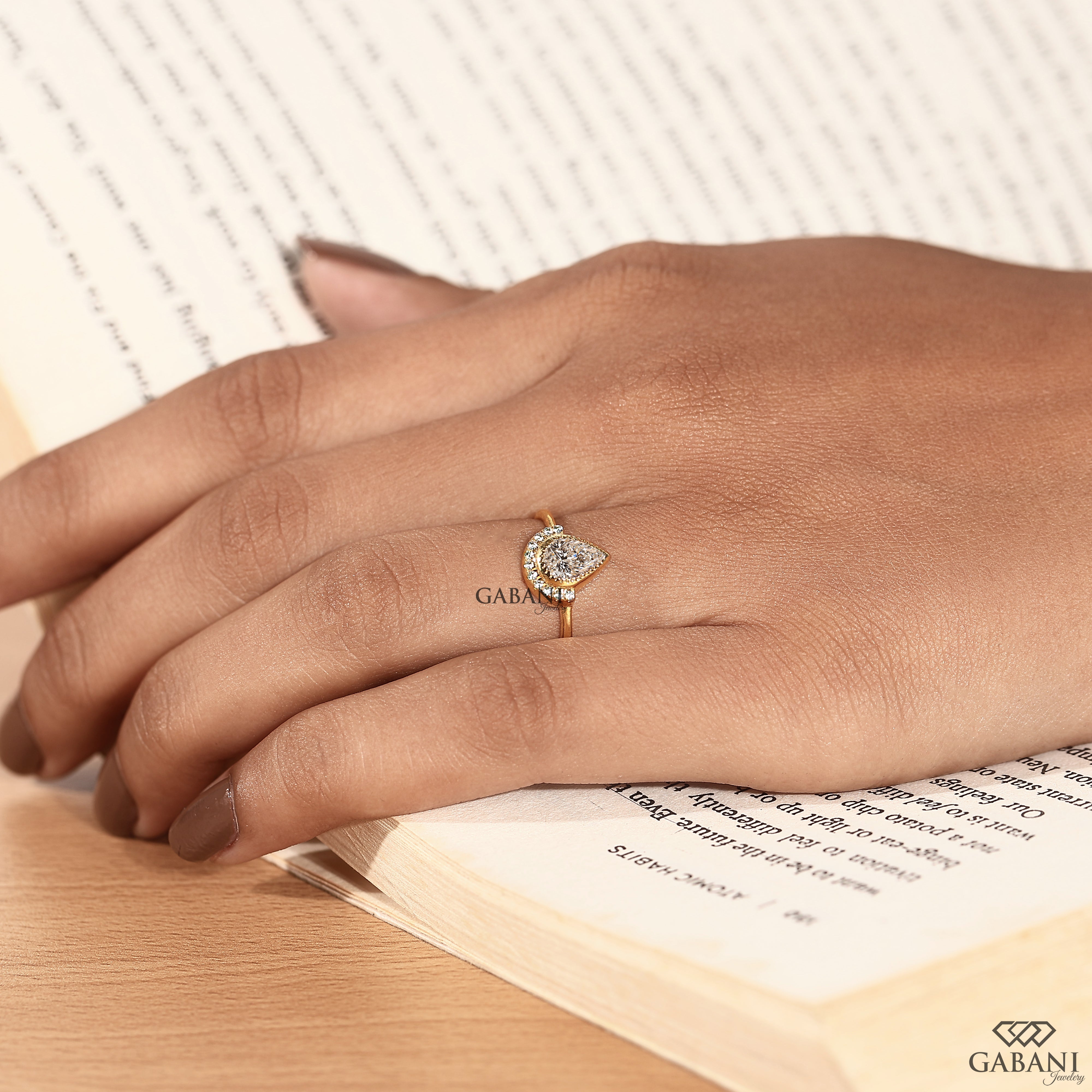 Yellow gold pear cut lab grown diamond engagement ring with side halo