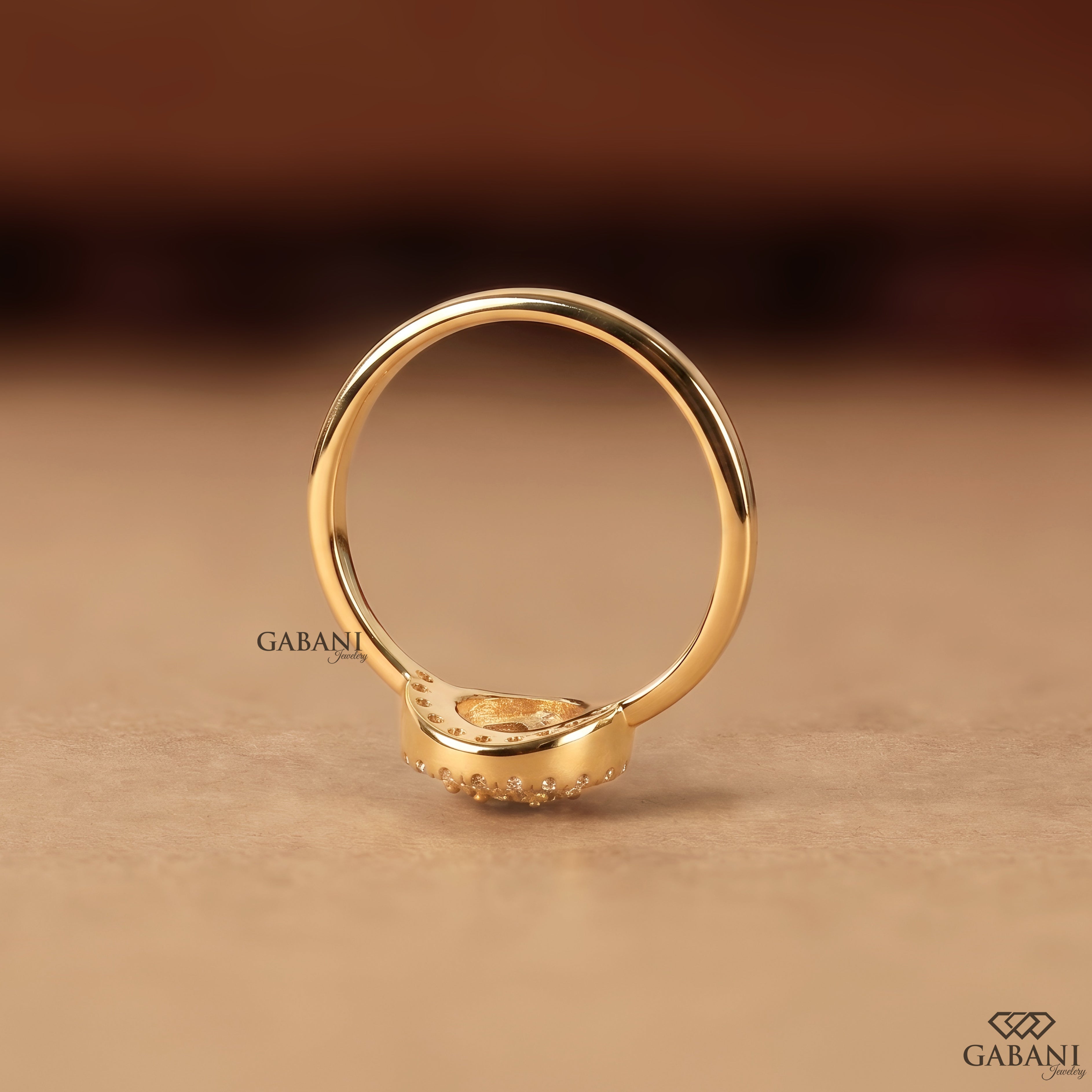 Pear shaped lab grown diamond engagement ring with round diamond halo