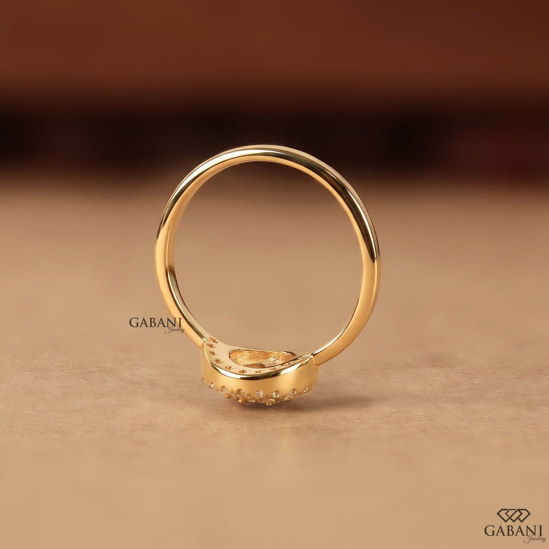 Pear shaped lab grown diamond engagement ring with round diamond halo