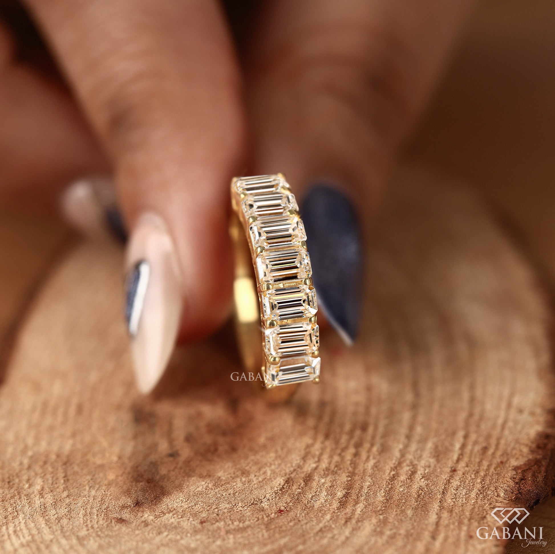 Emerald cut diamond band with seven lab grown stones in yellow gold
