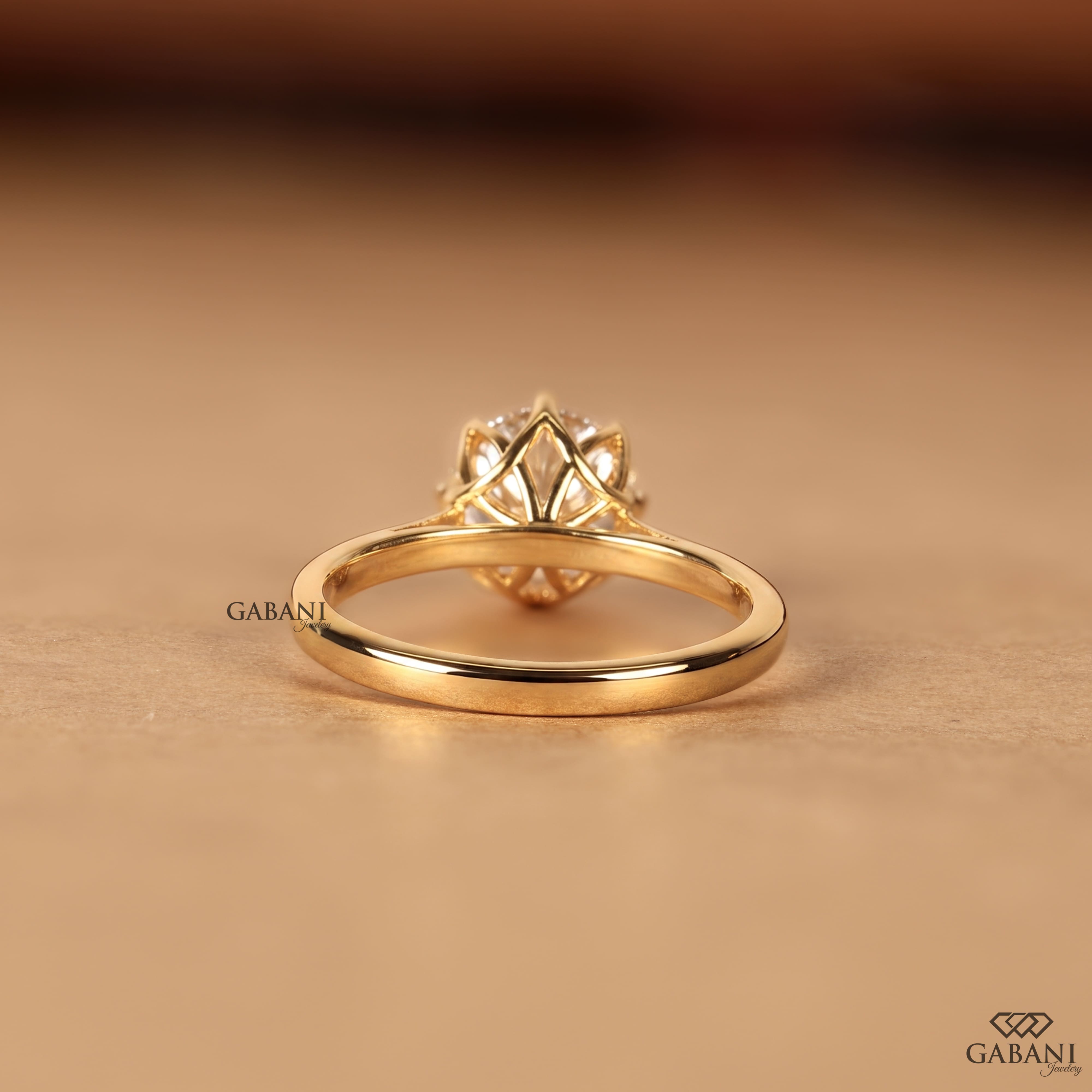 Shop a round Portuguese cut lab grown diamond solitaire engagement ring with a six-prong floral basket and polished yellow gold band.