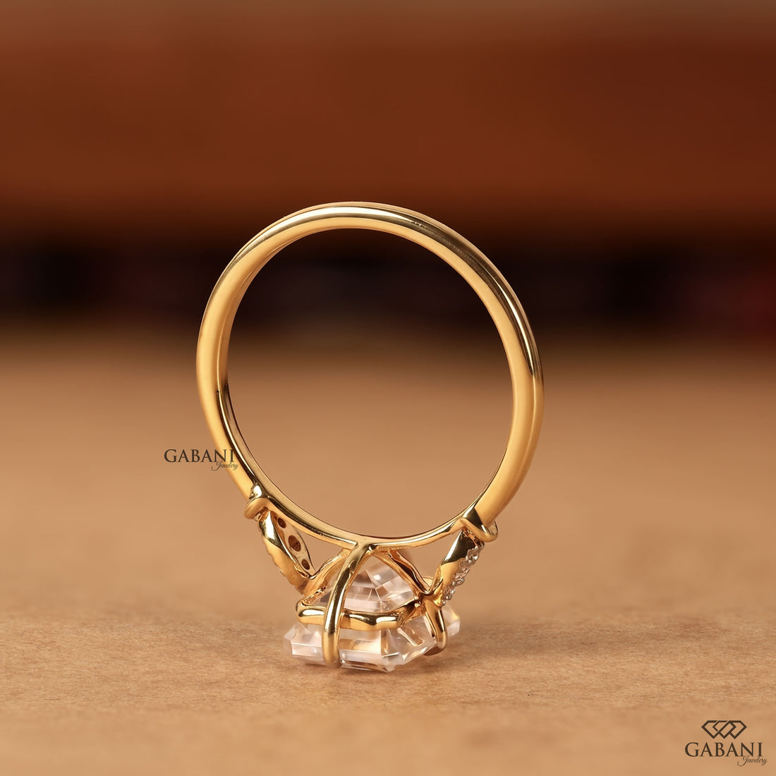 IGI certified emerald cut lab grown diamond ring featuring leaf inspired diamond side stones and elegant 18K gold bridal setting