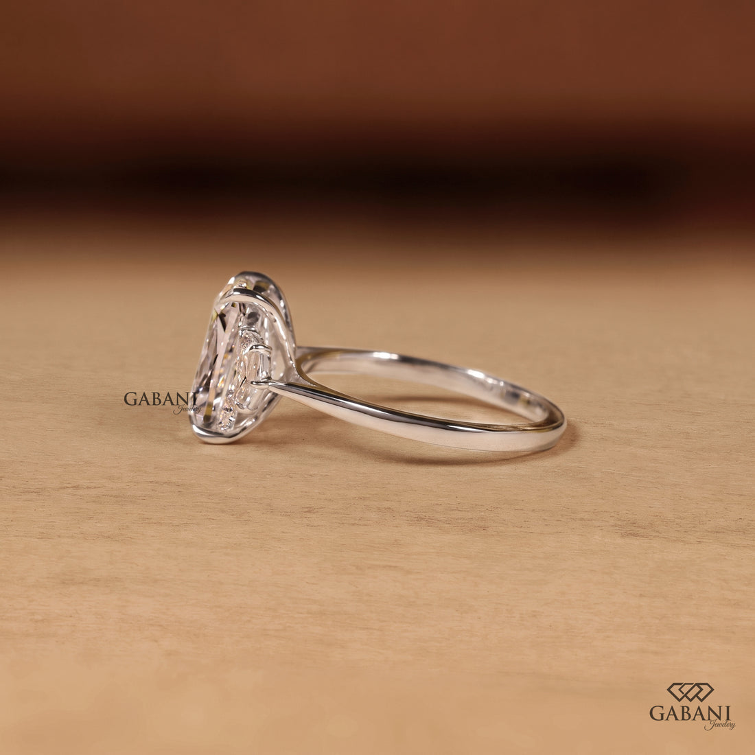 Cushion cut lab grown diamond three stone engagement ring with pear cut side diamonds in gold setting