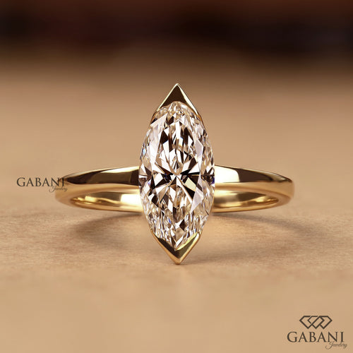 marquise cut lab grown diamond solitaire engagement ring with half bezel setting and polished 14K yellow gold band