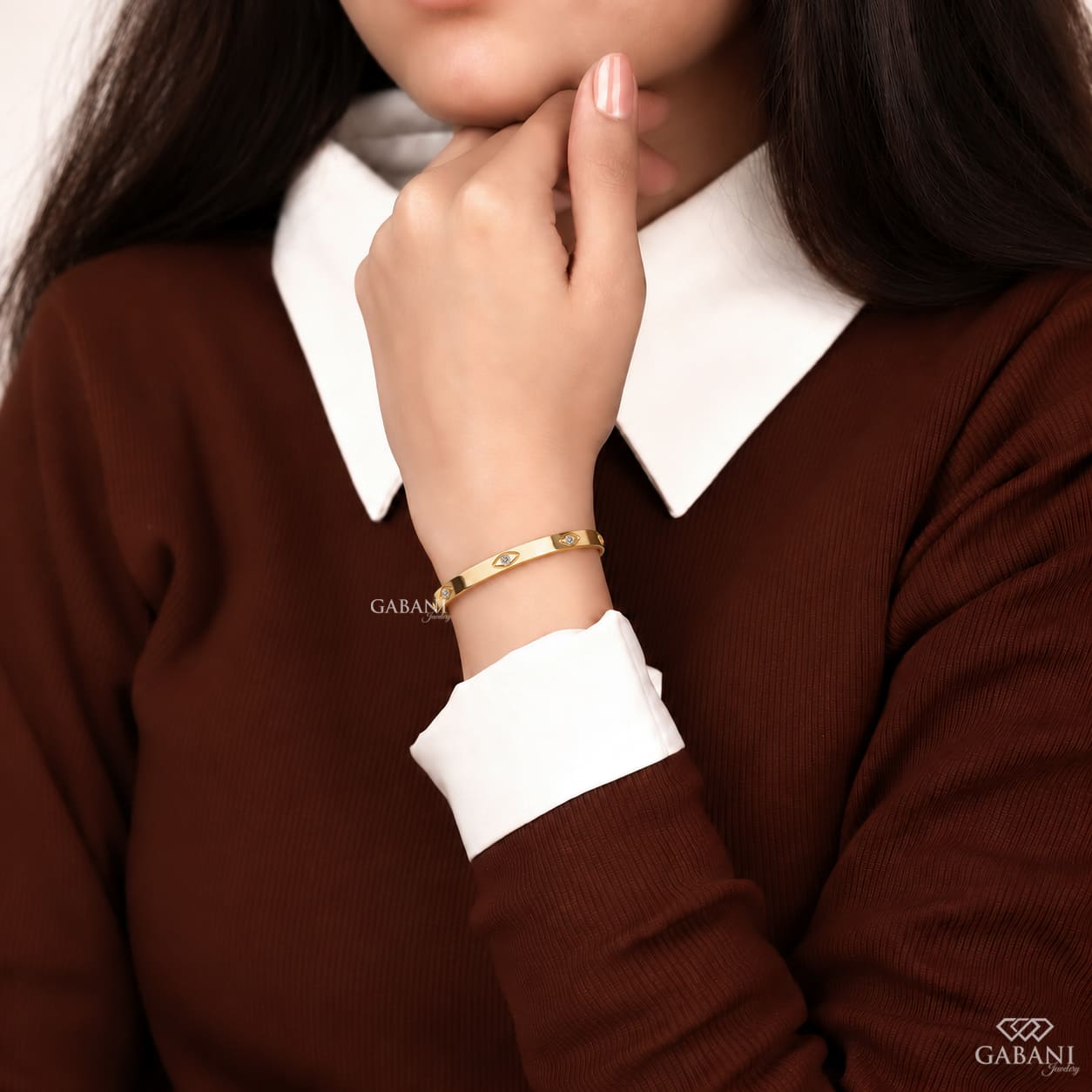 a round lab grown diamond station bangle bracelet in yellow gold, featuring evenly spaced round diamonds in polished bezel-style settings.