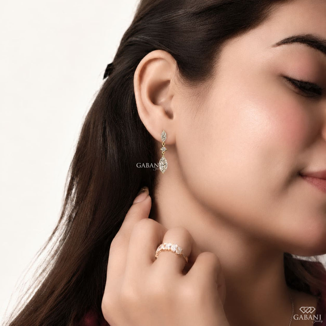 marquise and round cut lab grown diamond drop earrings in yellow gold, featuring two sparkling marquise diamonds connected by a round brilliant diamond on each earring, creating an elegant three-stone design by Gabani Jewelry.