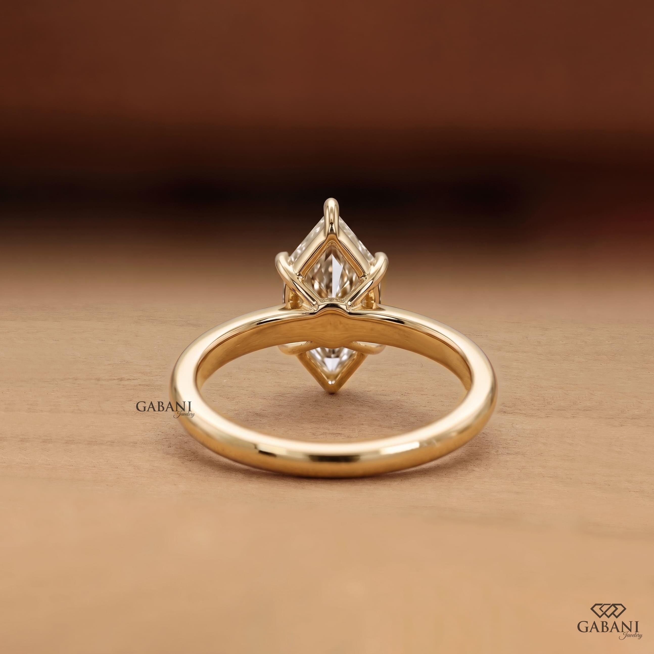 Marquise cut lab grown diamond engagement ring with six prong solitaire setting and classic 18K gold band