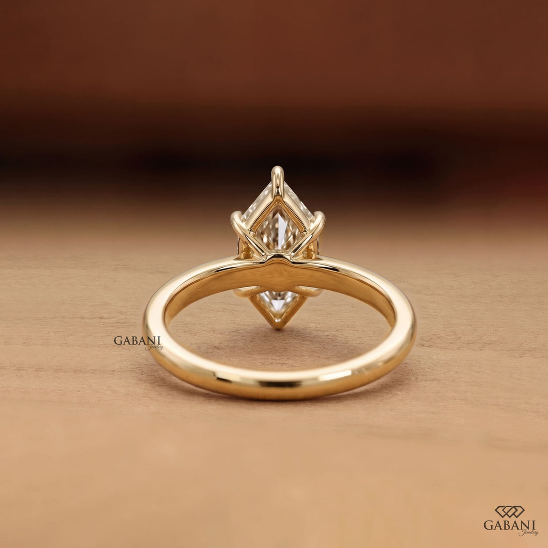 Marquise cut lab grown diamond engagement ring with six prong solitaire setting and classic 18K gold band