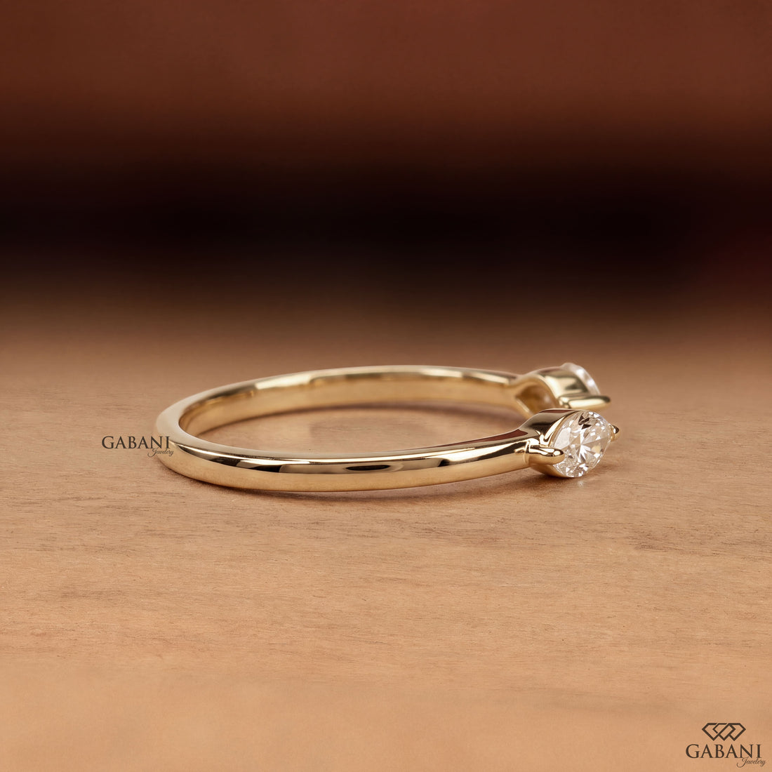 a marquise cut lab grown diamond open cuff ring in 14K yellow gold, featuring two horizontally set marquise diamonds in elegant half bezel settings with a modern minimalist design by Gabani Jewelry.