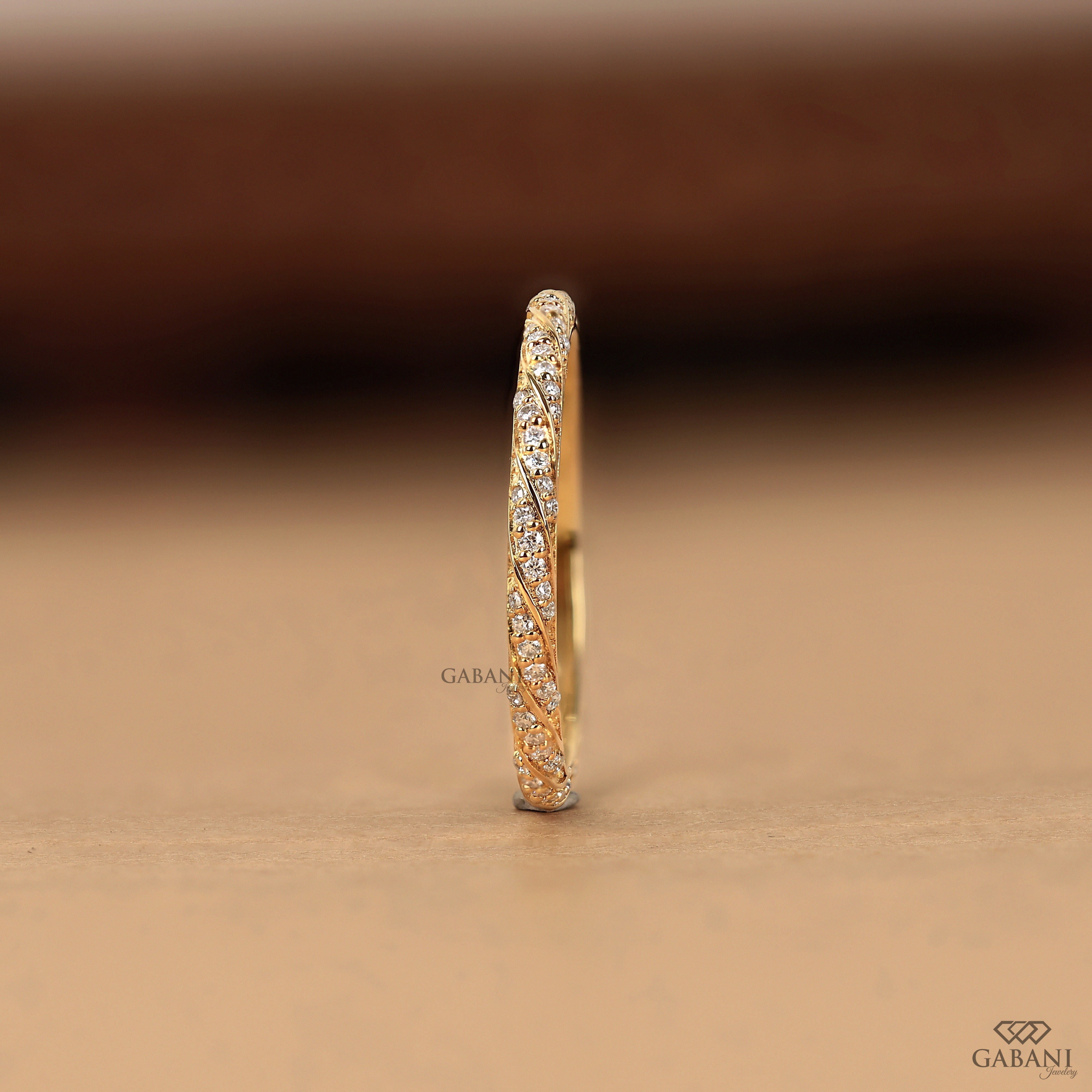a vintage-inspired lab grown diamond wedding band featuring flowing yellow gold vine curves, round diamond accents and fine milgrain edges, ideal for bridal stacking and anniversaries.