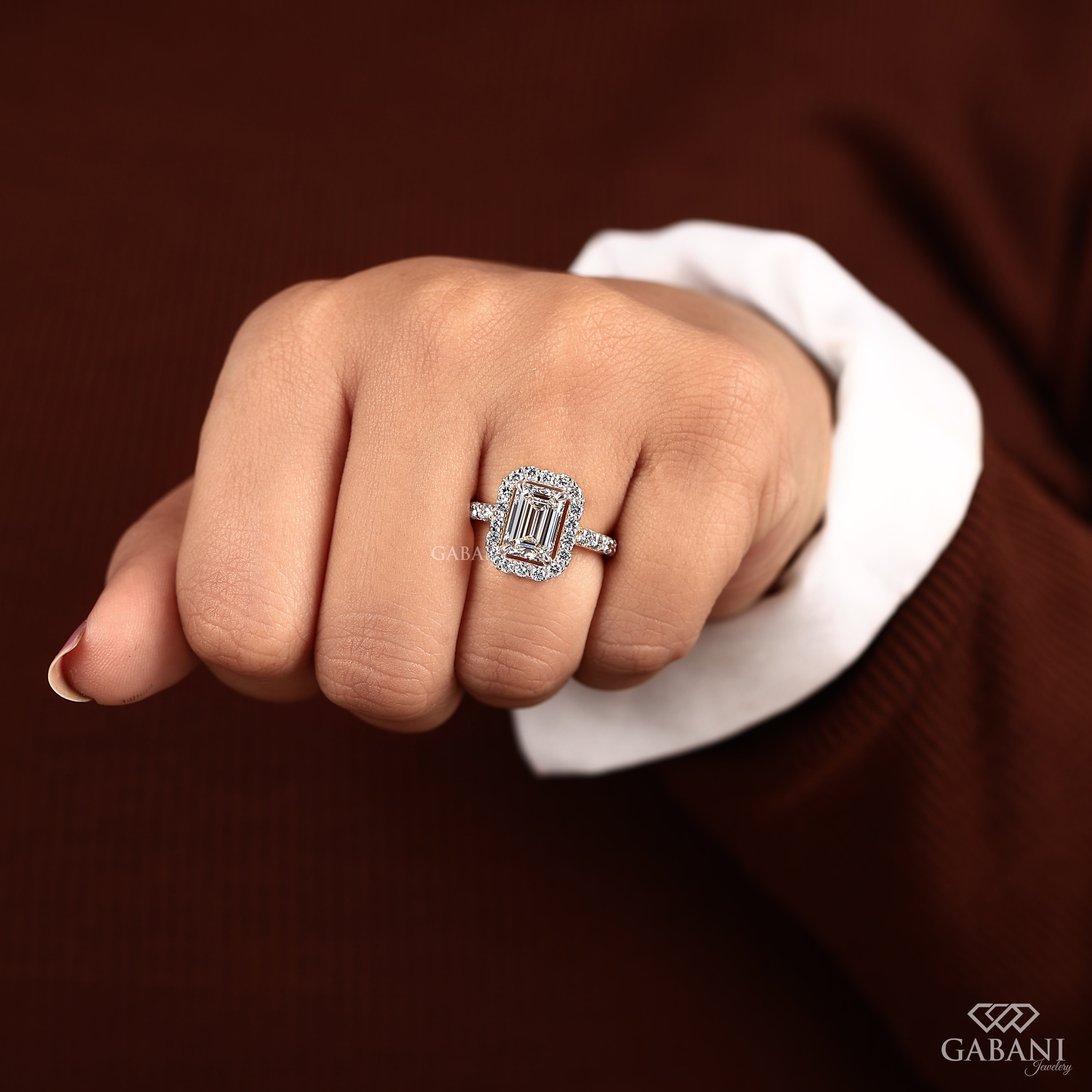 Emerald cut lab grown diamond engagement ring with round diamond halo, pave side stones, yellow gold band, IGI certified EF color VS1 clarity.