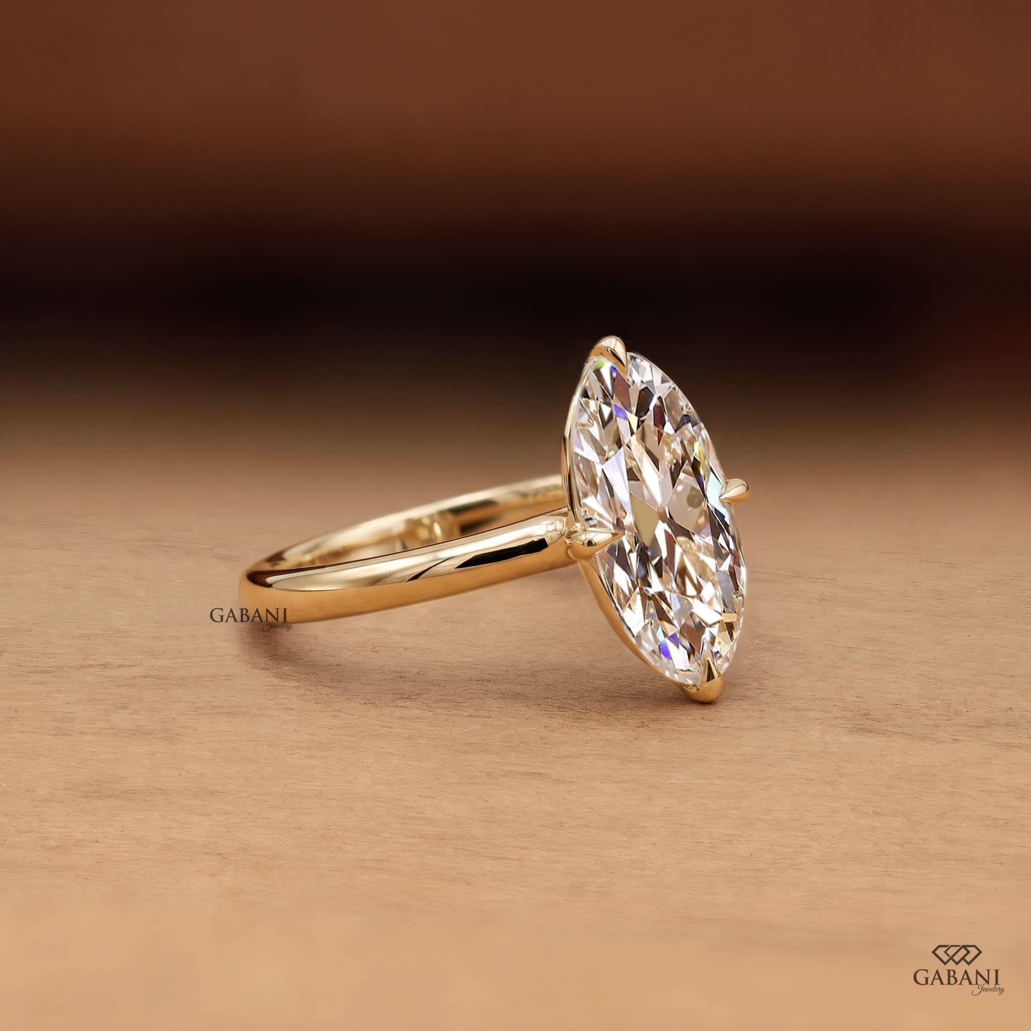 Oval old mine cut lab grown diamond engagement ring in 18K yellow gold with antique-style faceting, claw prong setting and polished solitaire band.