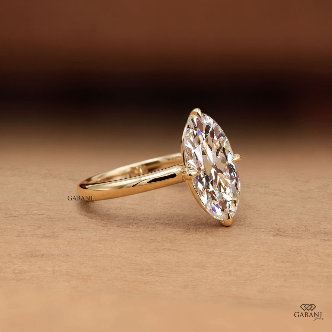 Oval old mine cut lab grown diamond engagement ring in 18K yellow gold with antique-style faceting, claw prong setting and polished solitaire band.