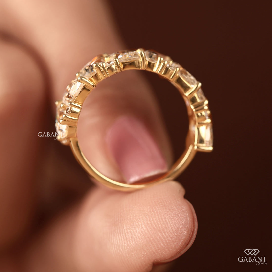 diamond half eternity wedding band in yellow gold with alternating prong set diamond design.