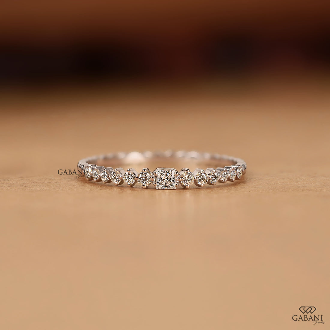 Princess cut and round lab grown diamond wedding band in white gold with graduated prong set diamond design.