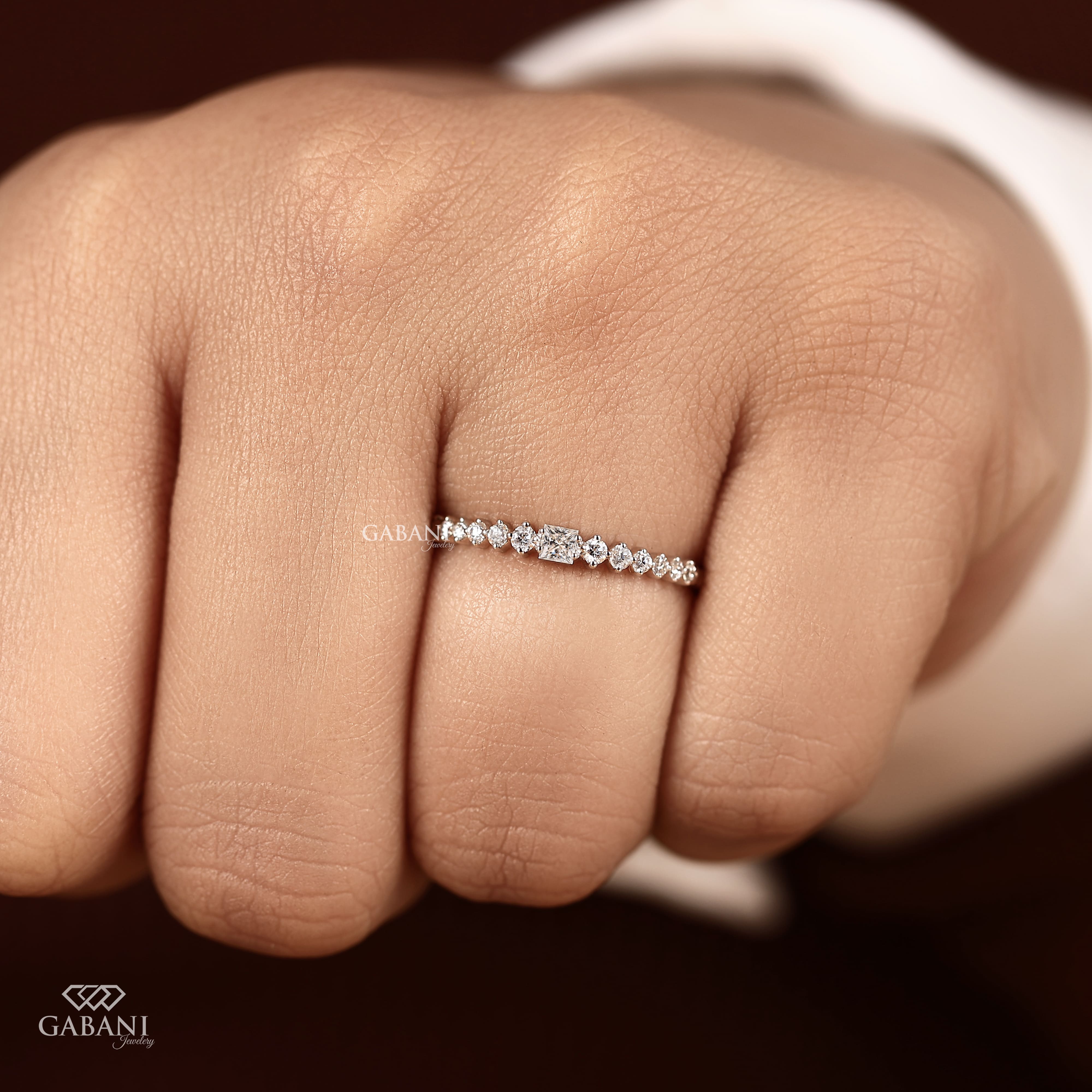 Princess cut and round lab grown diamond wedding band in white gold with graduated prong set diamond design.