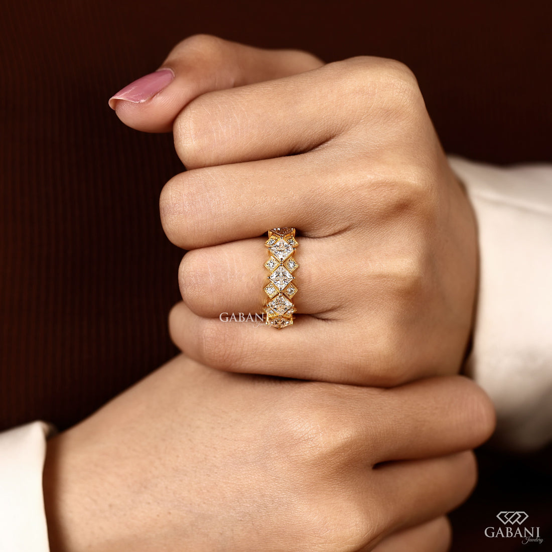 Princess cut lab grown diamond wedding band in yellow gold with round diamond accents and a geometric half eternity design for bridal and anniversary wear.