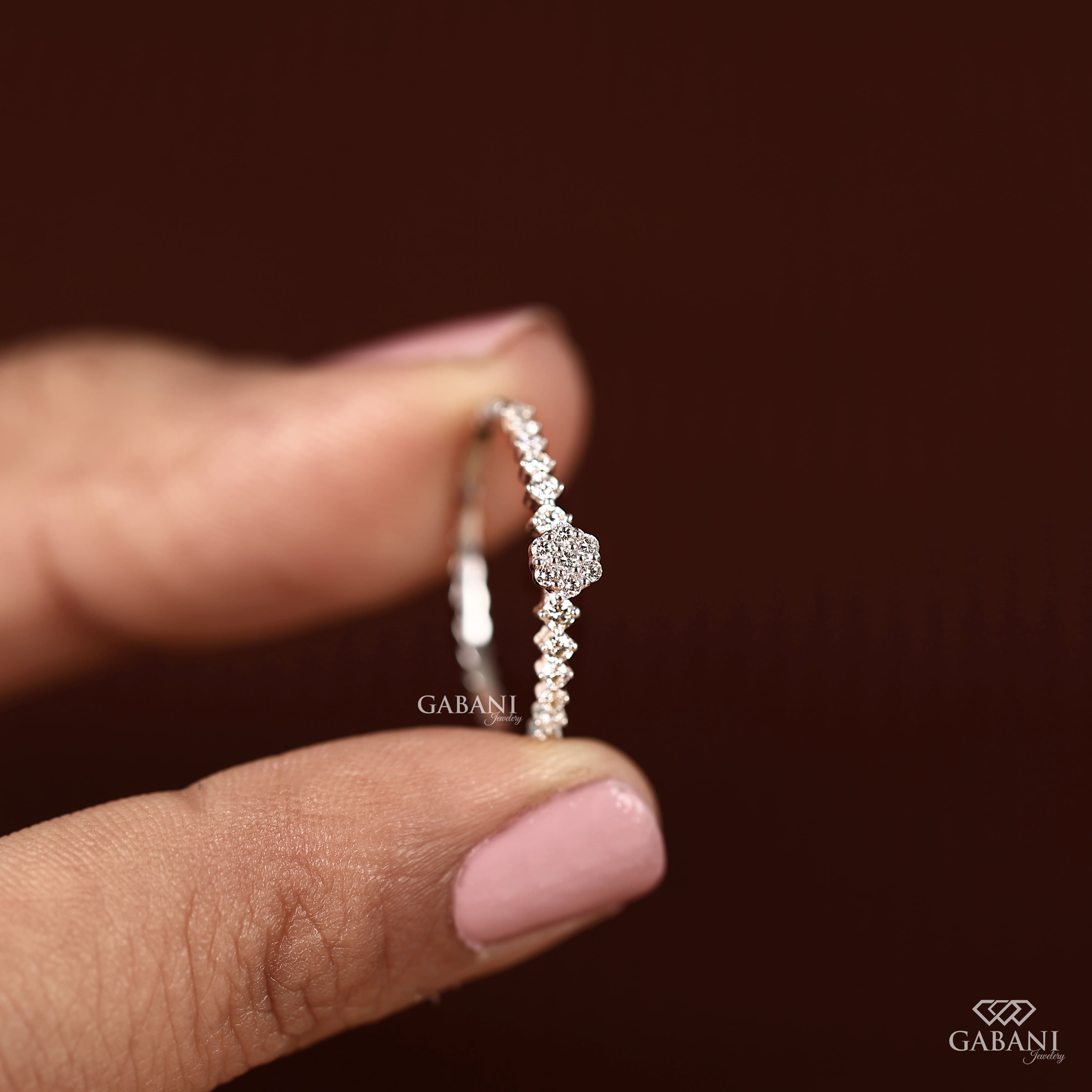 Round lab grown diamond floral cluster wedding band in white gold with graduated side diamonds and prong setting.