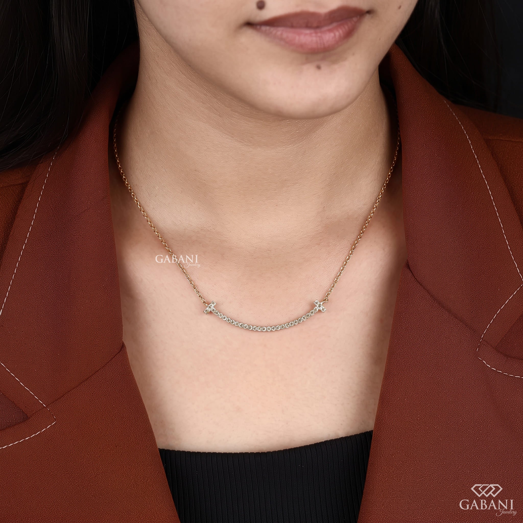 Curved bar lab grown diamond necklace in yellow gold featuring round pavé set diamonds, T-shaped ends and a delicate gold chain.