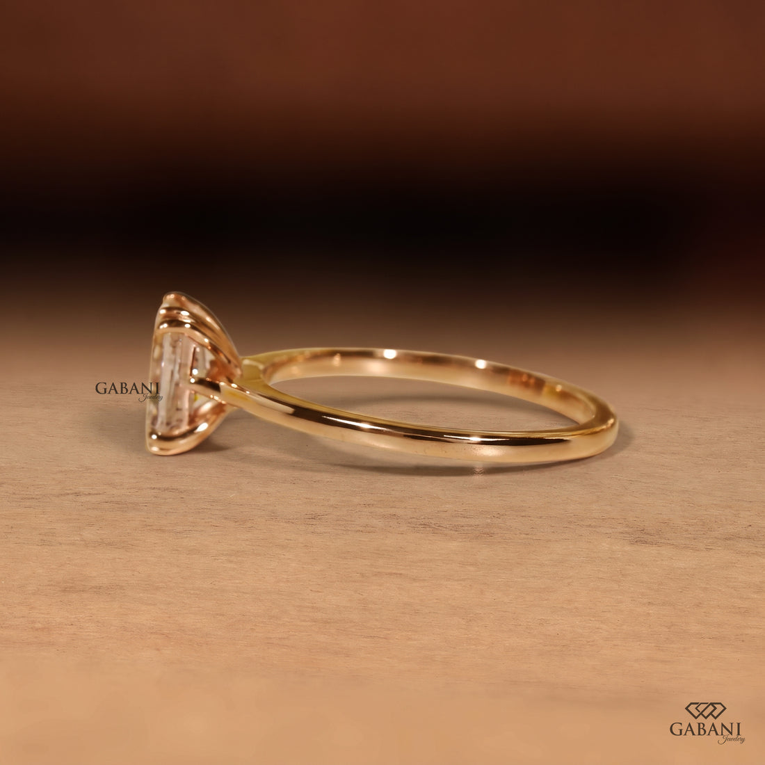 Radiant cut lab grown diamond engagement ring in 18K yellow gold with double claw prongs, elongated center stone and a slim polished solitaire band.