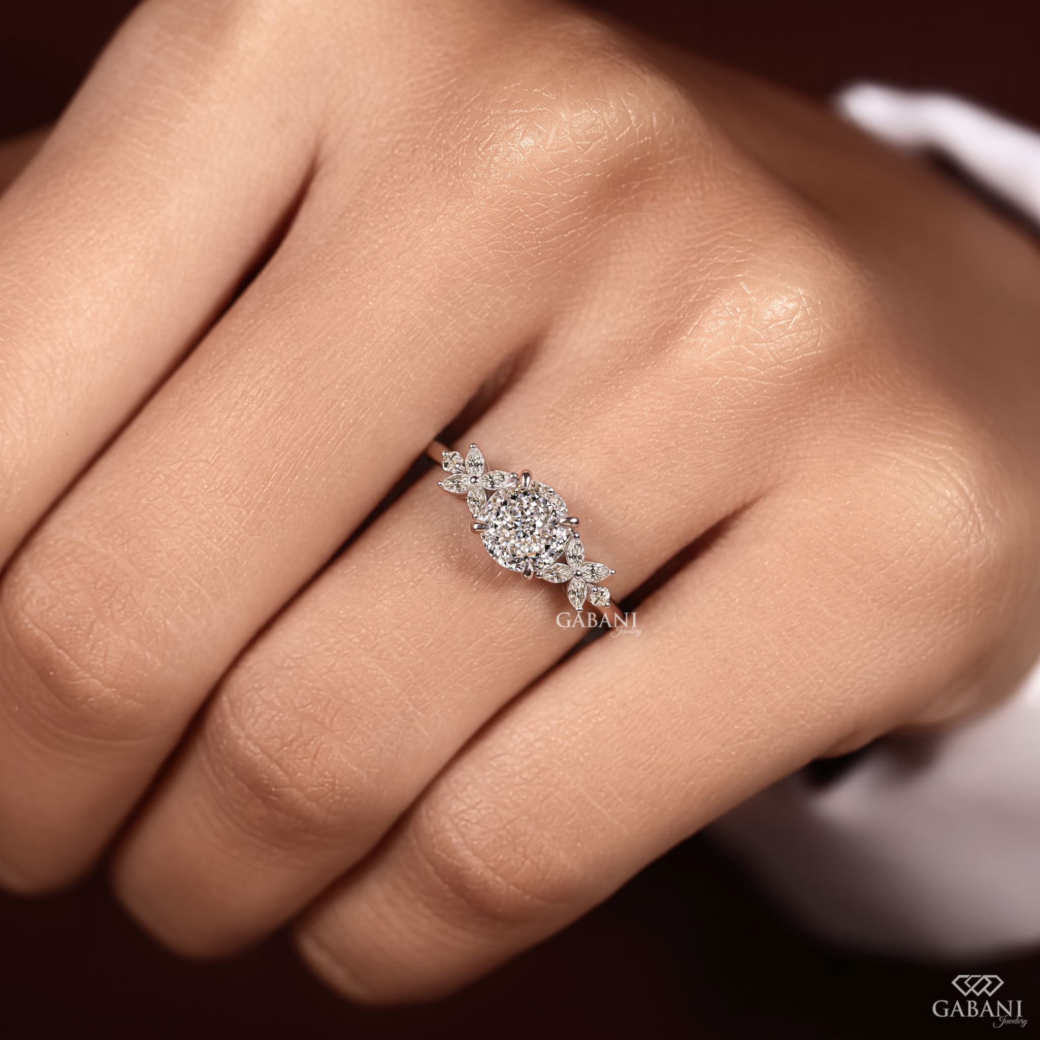 Round Portuguese cut lab grown diamond engagement ring with marquise leaf side stones in polished white gold.