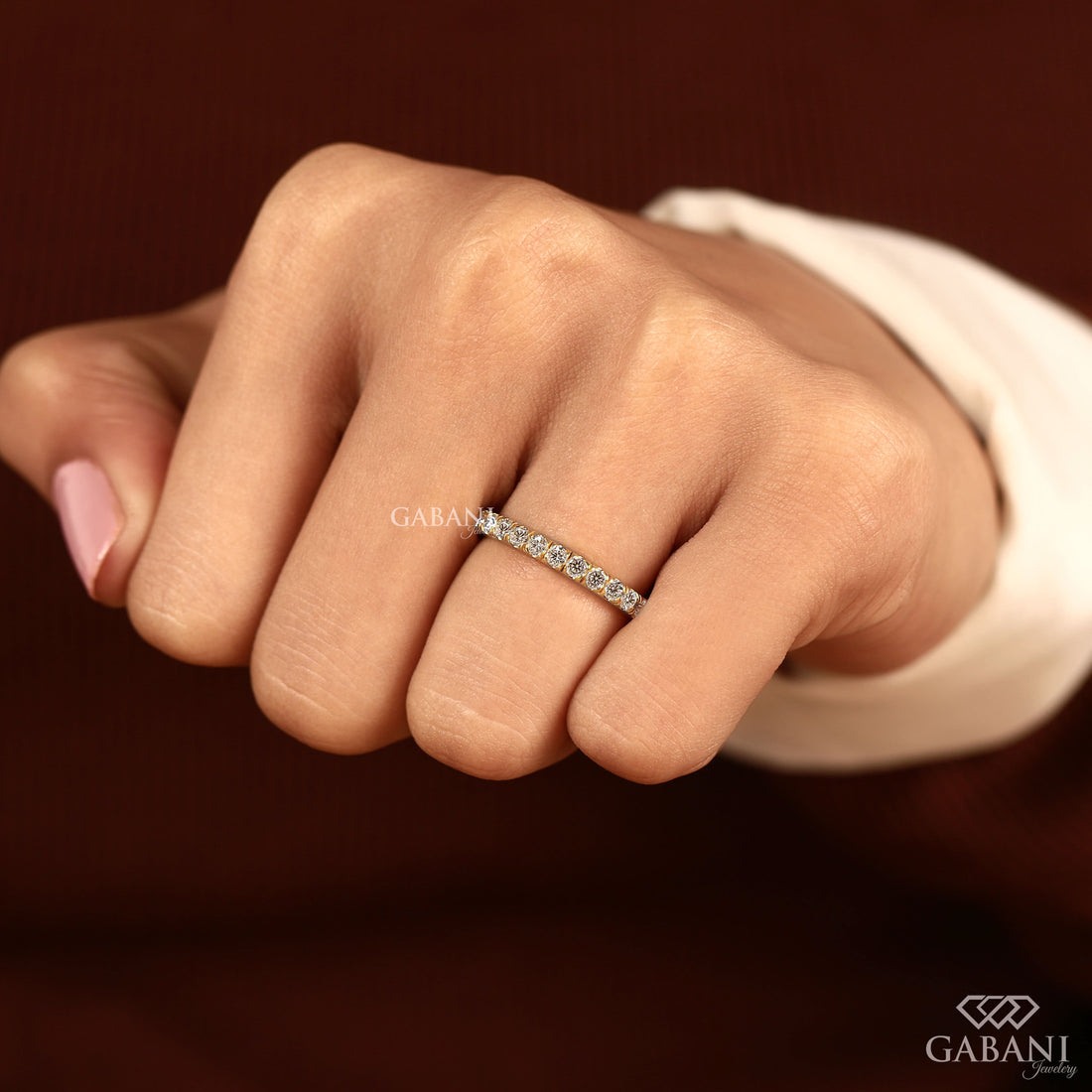 Round cut lab grown diamond eternity wedding band in yellow gold with continuous diamond setting and classic bridal style.