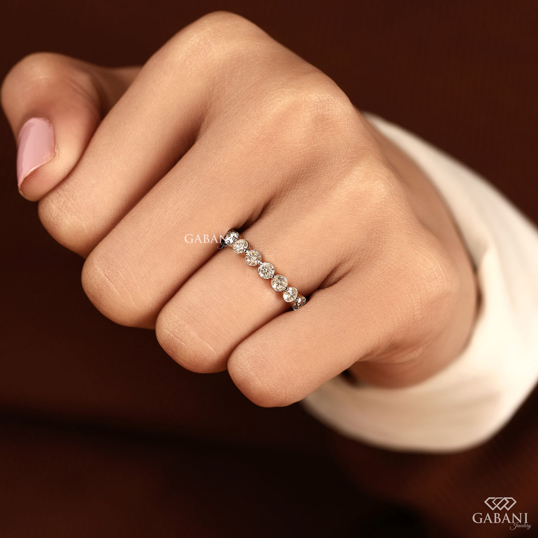 Round cut lab grown diamond full eternity wedding band in yellow gold with shared prong setting.