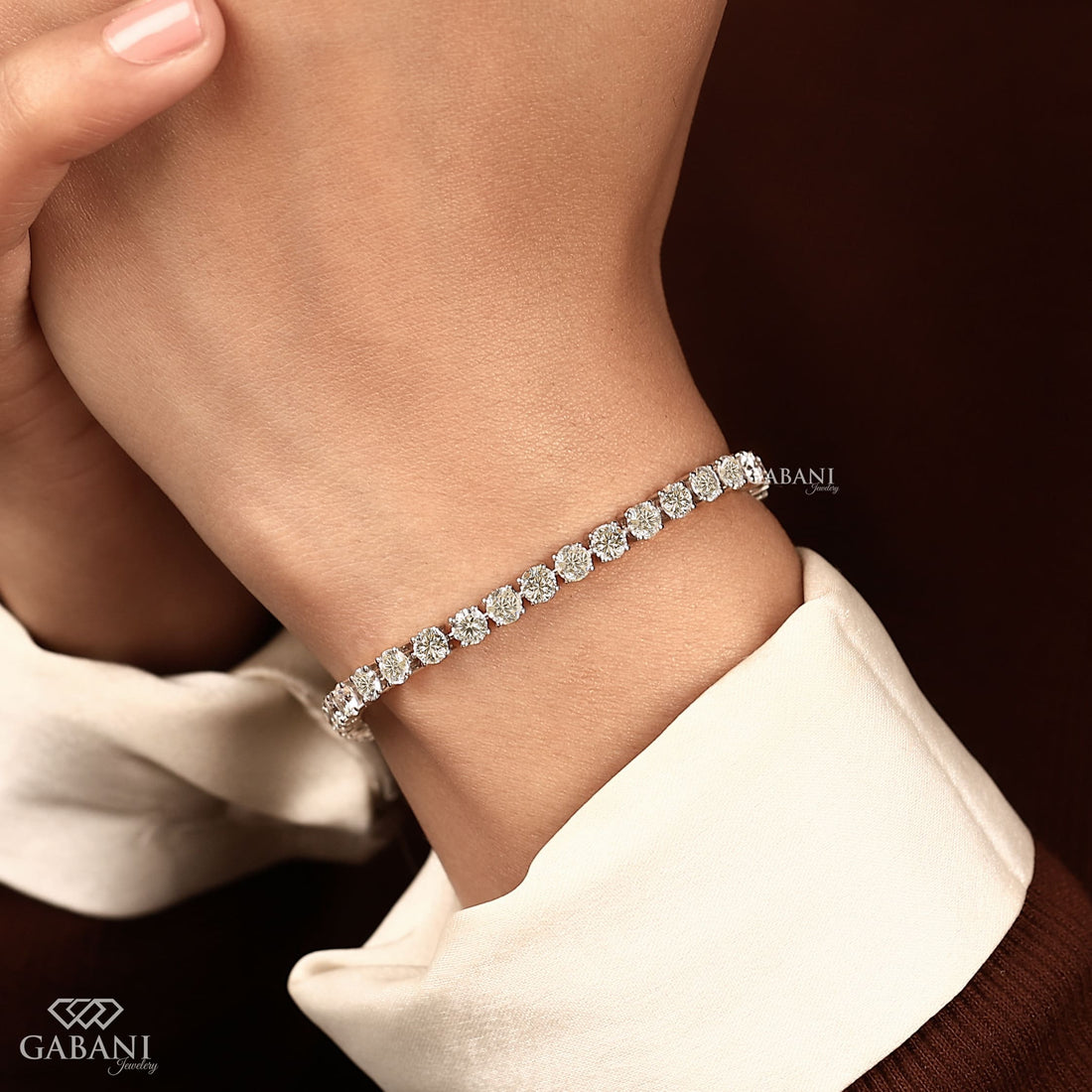 Round cut lab grown diamond tennis bracelet with EF color VS1 clarity diamonds in classic four prong settings and secure clasp.