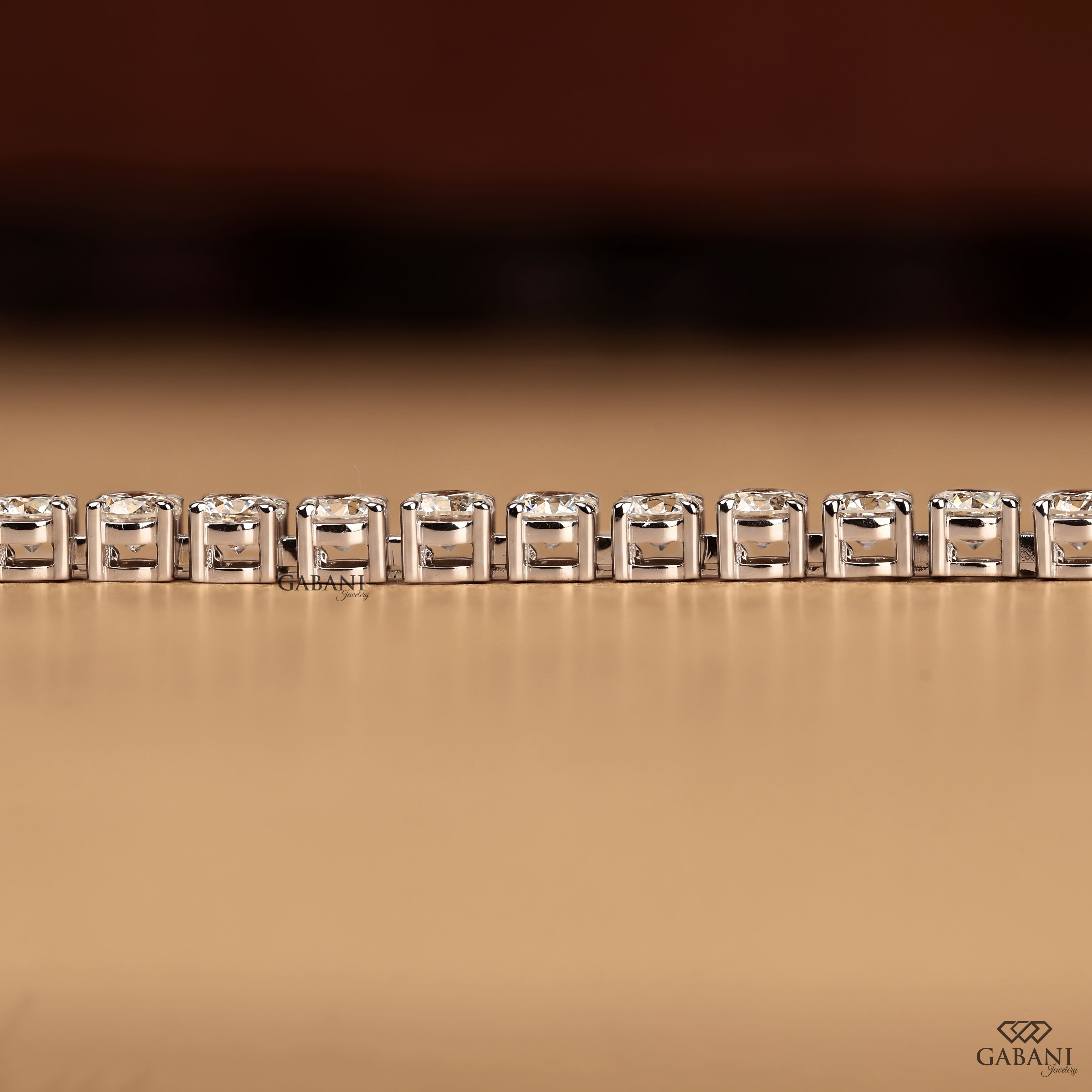 Round cut lab grown diamond tennis bracelet with EF color VS1 clarity diamonds in classic four prong settings and secure clasp.