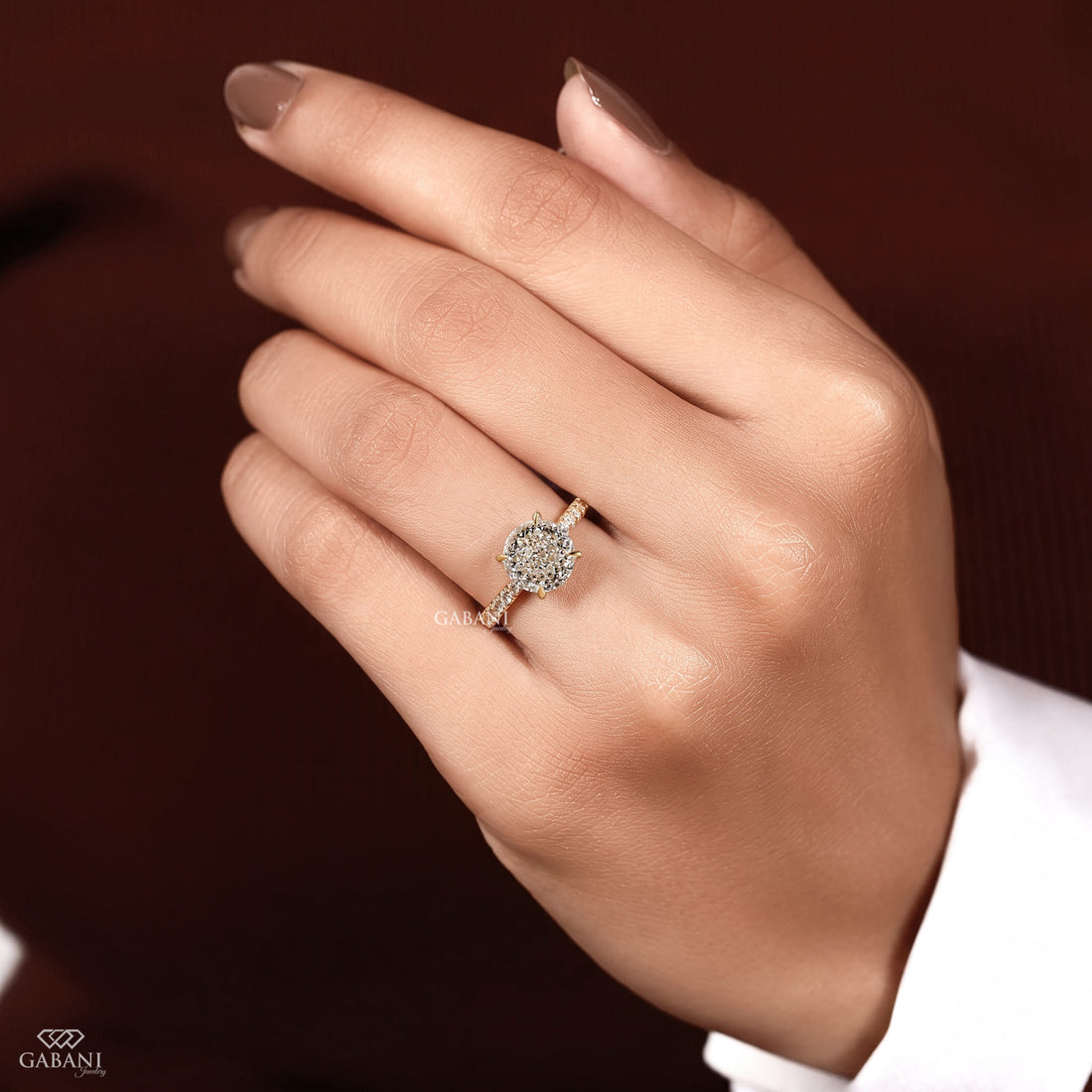 Round Portuguese cut lab grown diamond cathedral engagement ring in yellow gold with a four-prong center setting and pave diamond shoulders.