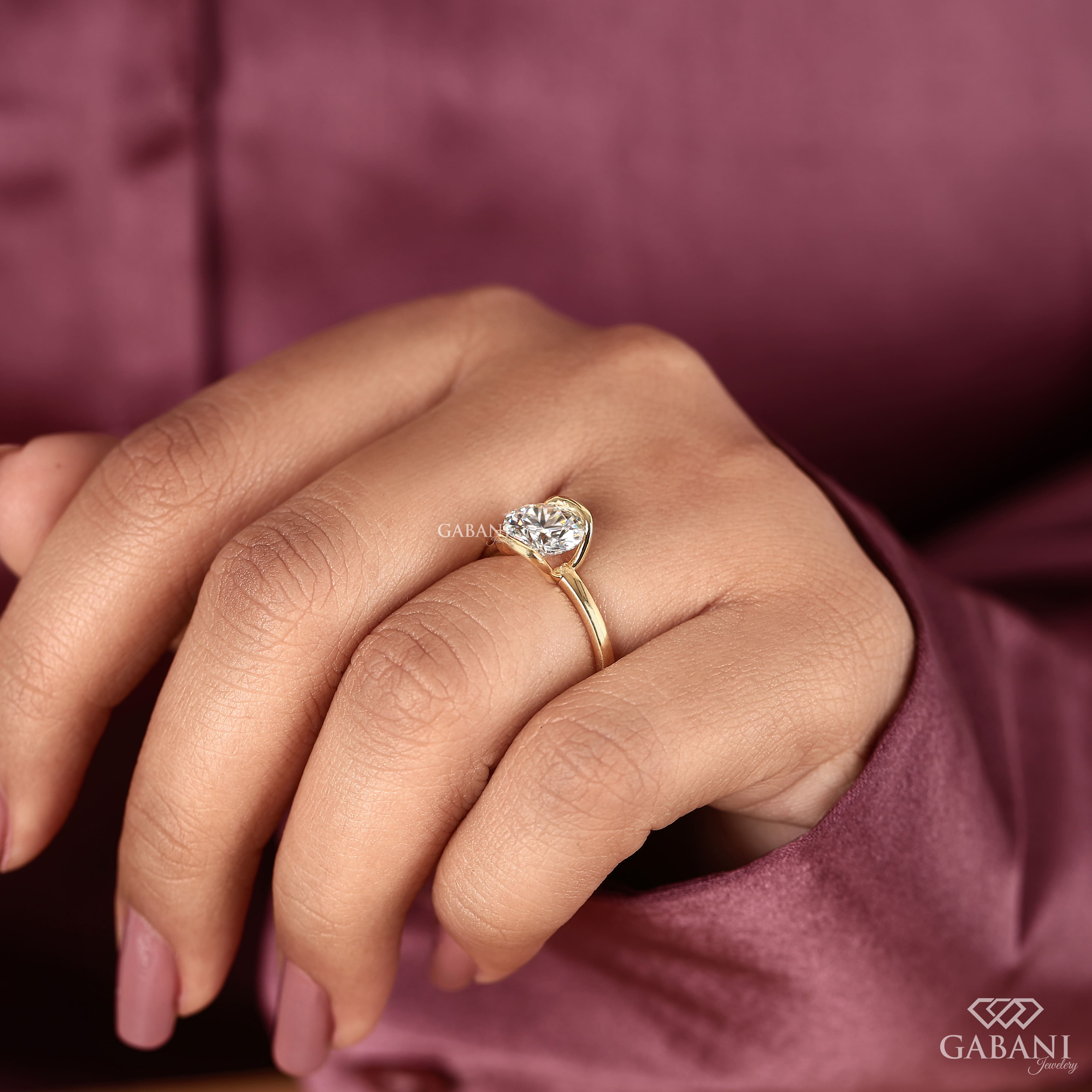 Round diamond half bezel solitaire engagement ring in yellow gold with a slim straight polished band.