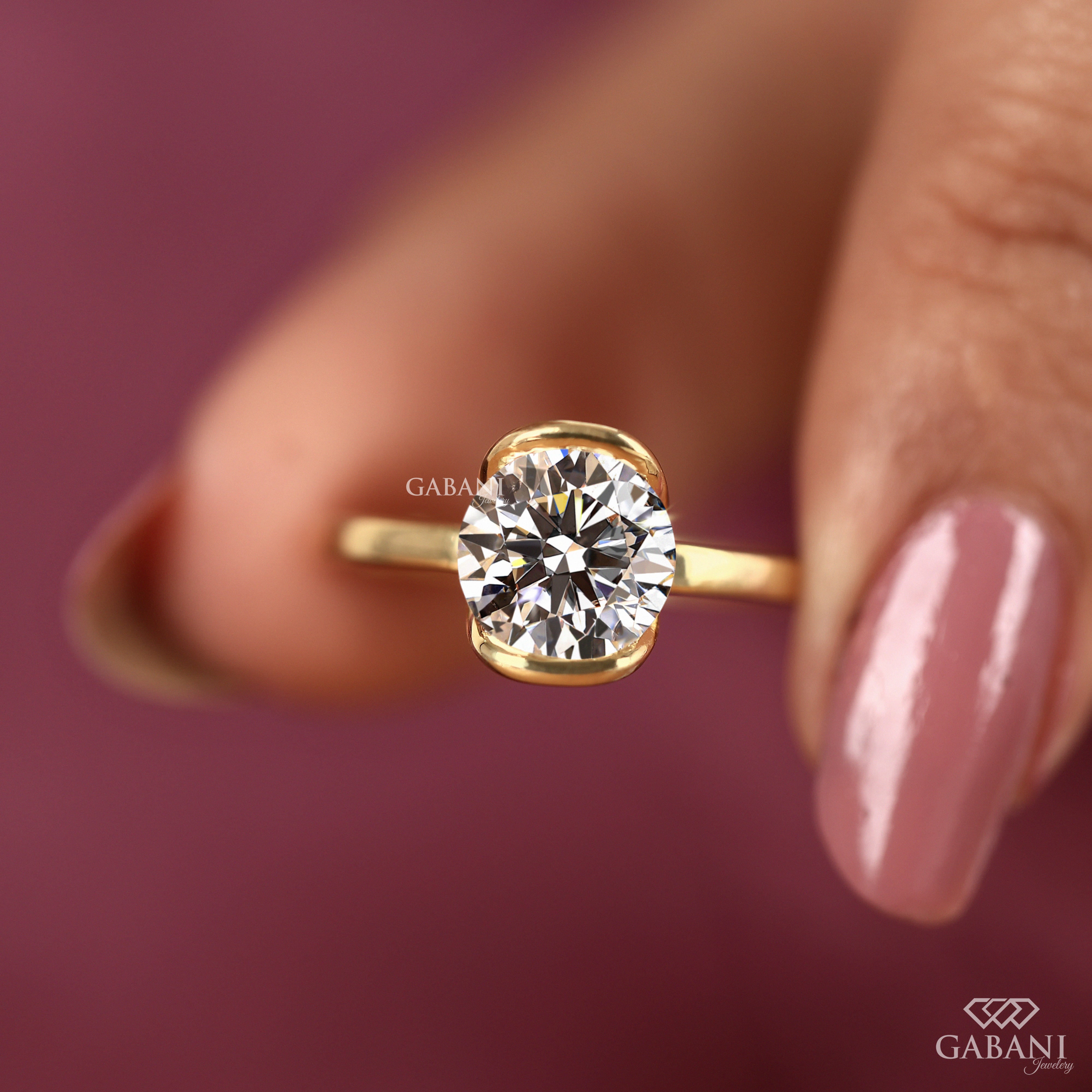 Round diamond half bezel solitaire engagement ring in yellow gold with a slim straight polished band.