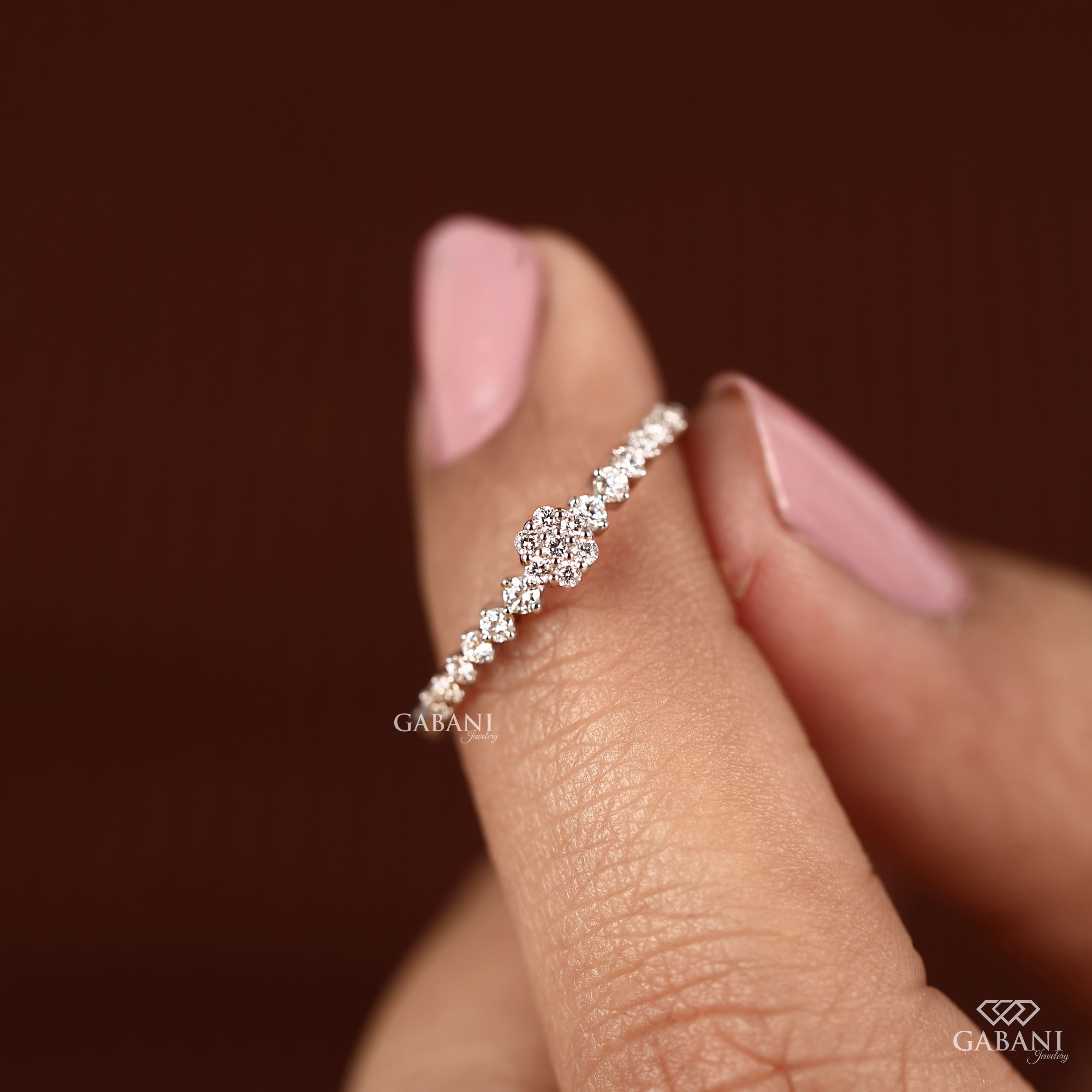 Round lab grown diamond floral cluster wedding band in white gold with graduated side diamonds and prong setting.