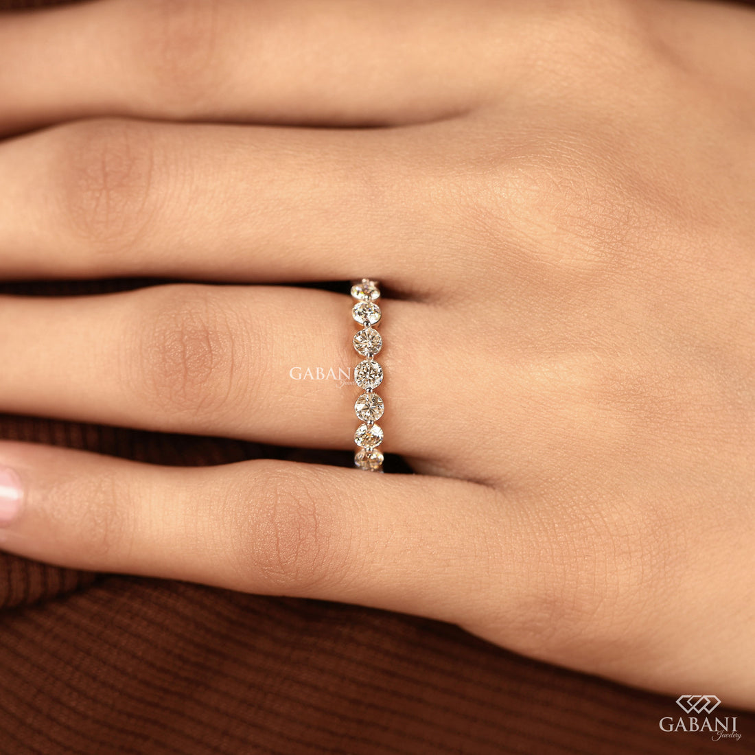 Round cut lab grown diamond full eternity wedding band in yellow gold with shared prong setting.