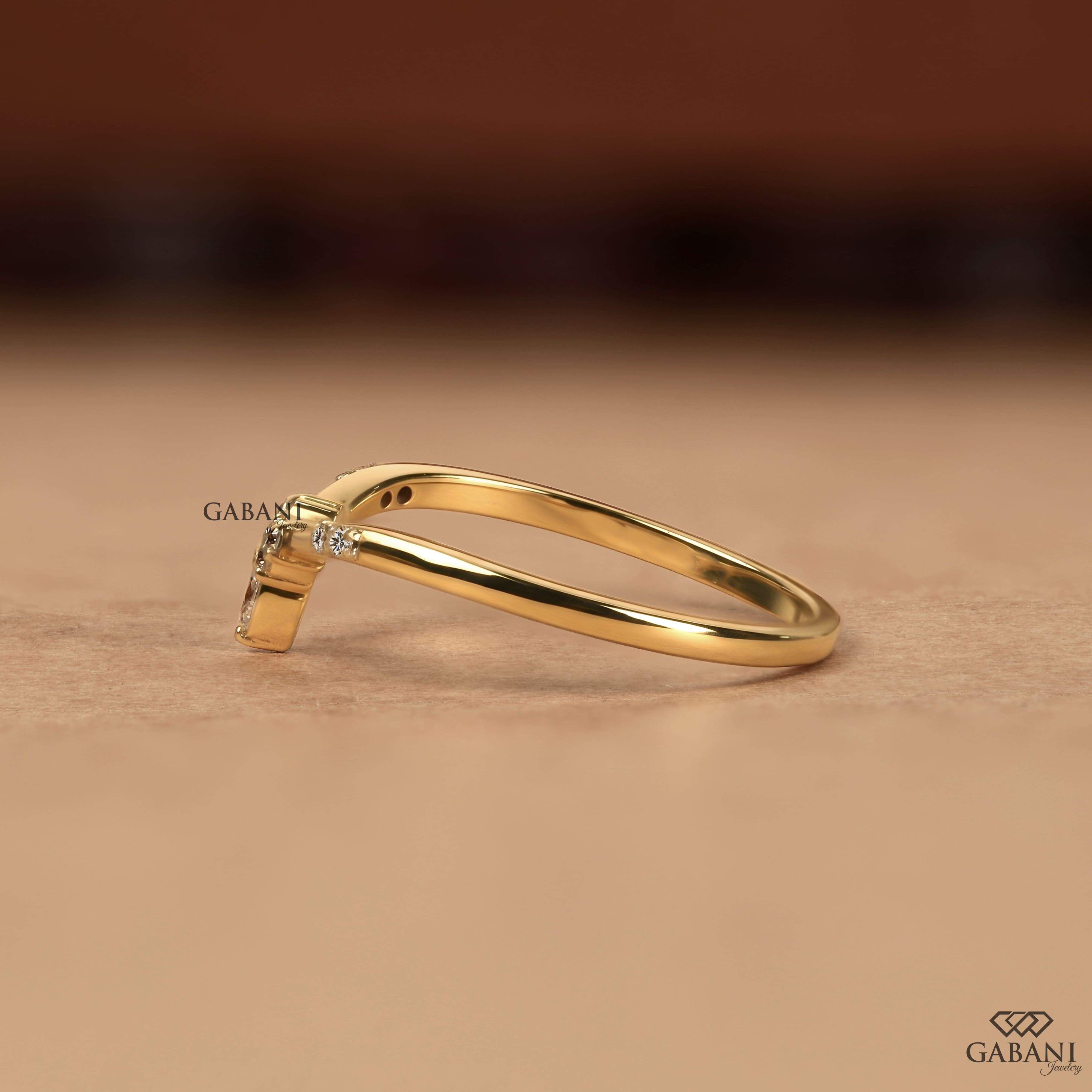 Marquise and round cut lab grown diamond curved wedding band in yellow gold with V shaped contour design for stacking with an engagement ring.
