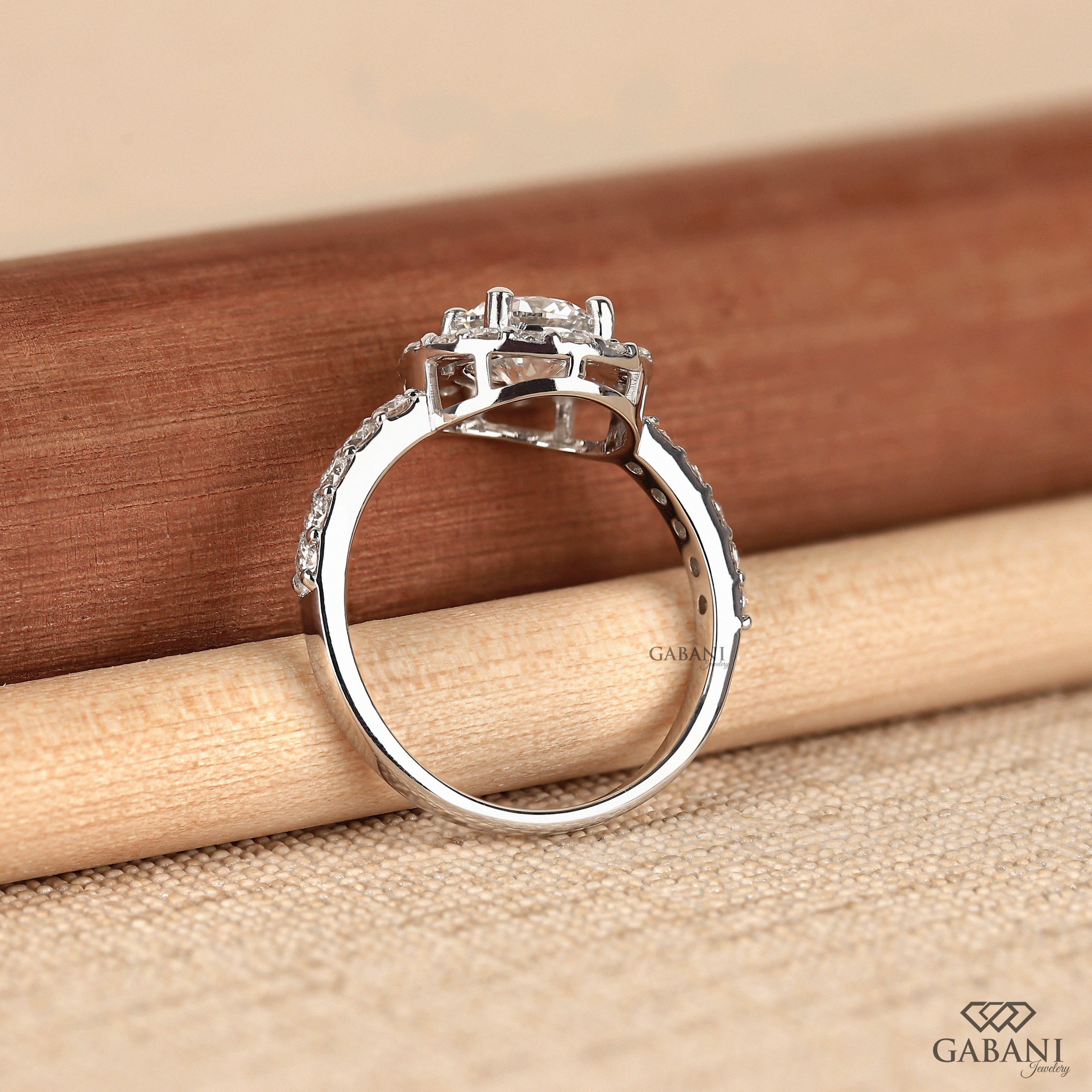 Round cut lab grown diamond halo engagement ring with pave diamond band, yellow gold setting, IGI certified EF color VS1 clarity.