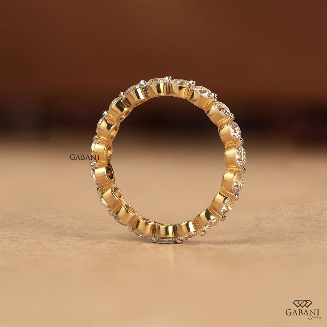 Round cut lab grown diamond full eternity wedding band in yellow gold with shared prong setting.