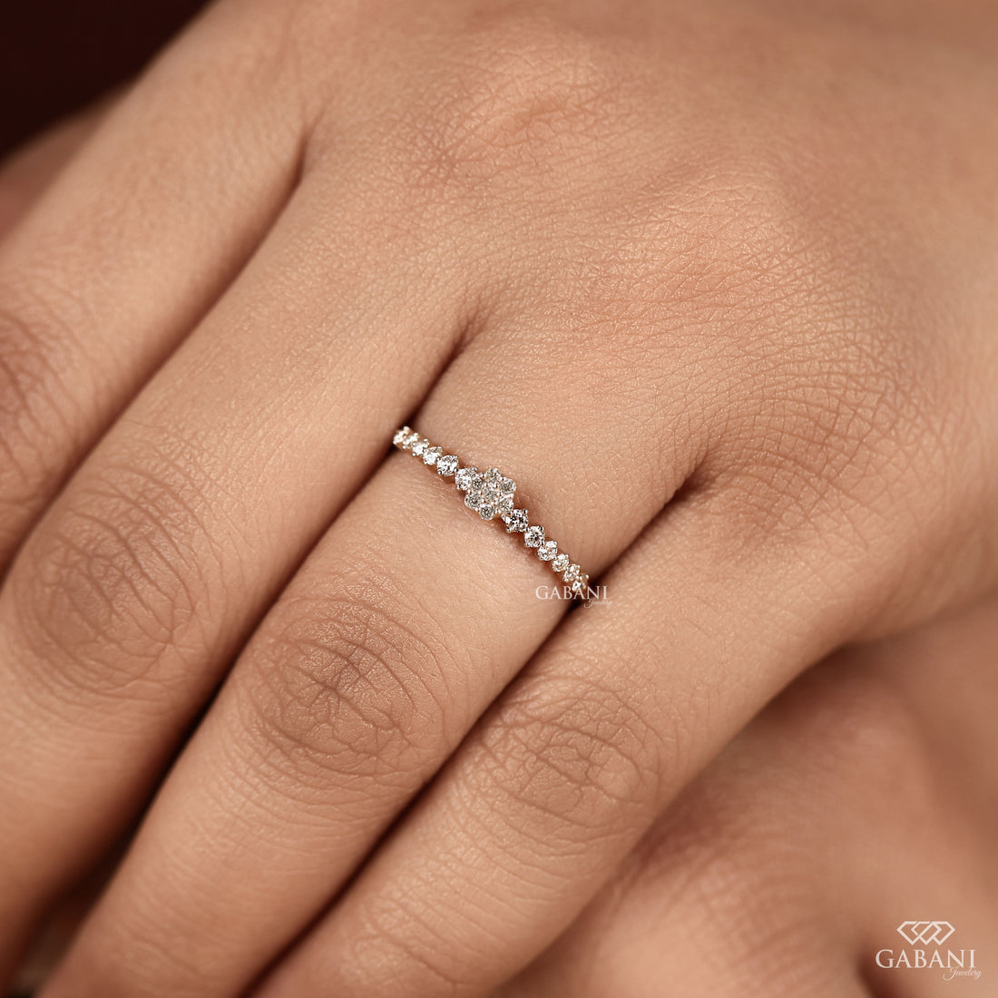 Round lab grown diamond floral cluster wedding band in white gold with graduated side diamonds and prong setting.