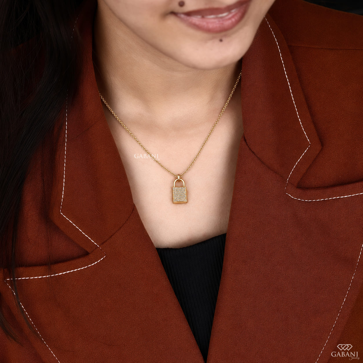 Yellow gold padlock pendant necklace featuring rows of round cut lab grown diamonds in a pavé setting with a polished gold shackle.