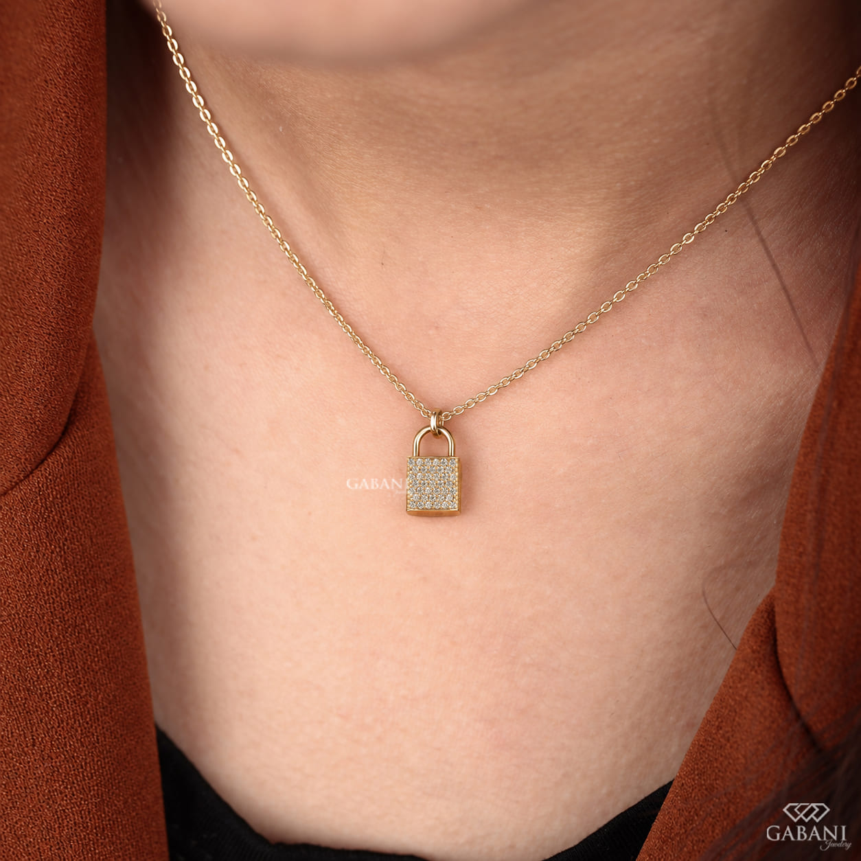 Yellow gold padlock pendant necklace featuring rows of round cut lab grown diamonds in a pavé setting with a polished gold shackle.