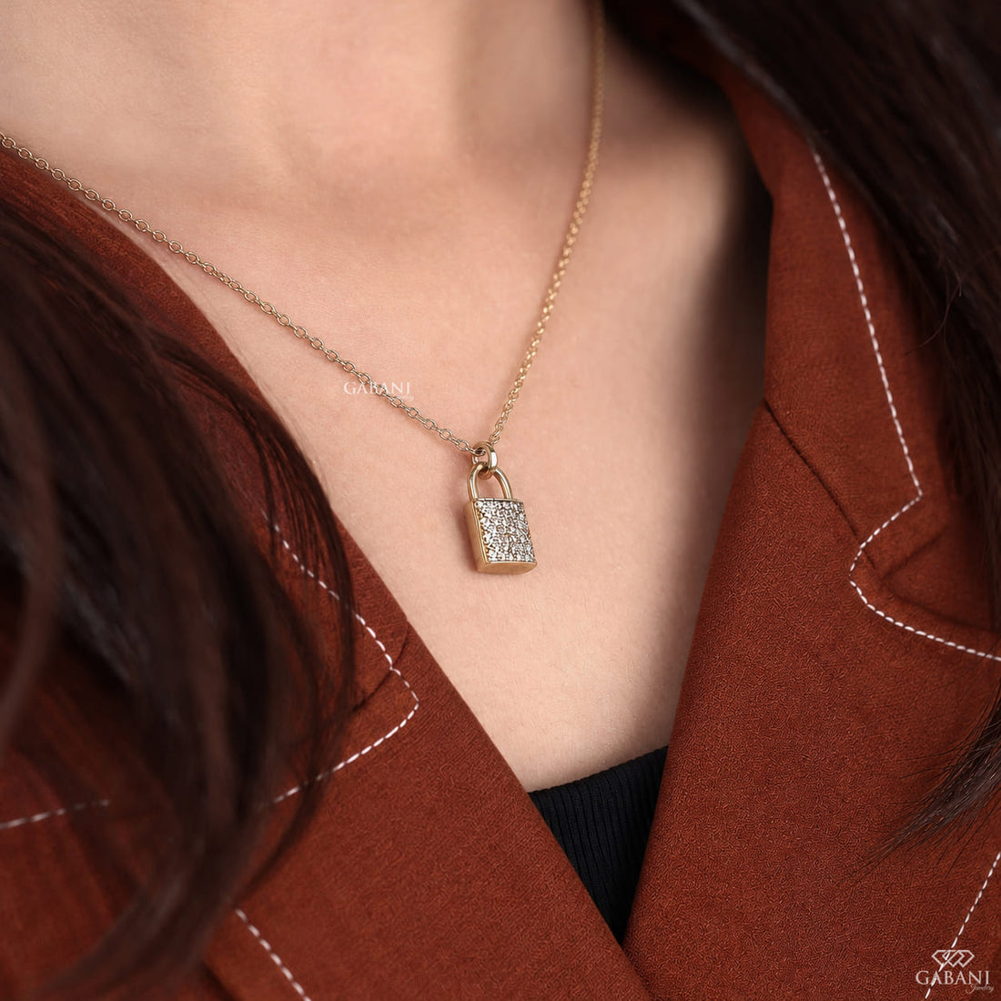 round cut lab grown diamonds in a pavé setting with a polished gold shackle.