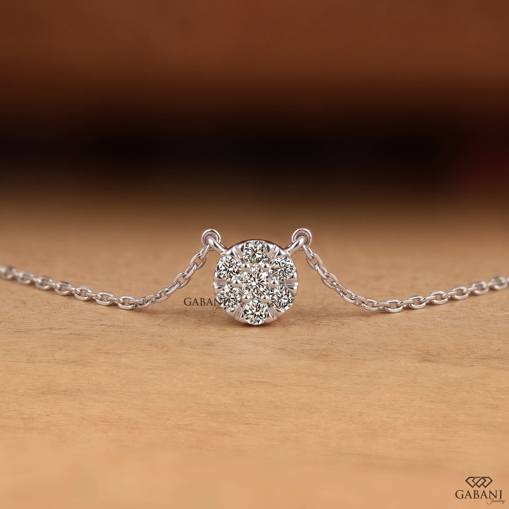 Seven stone round cut lab grown diamond floral cluster necklace in 18K white gold with a delicate cable chain and prong setting.