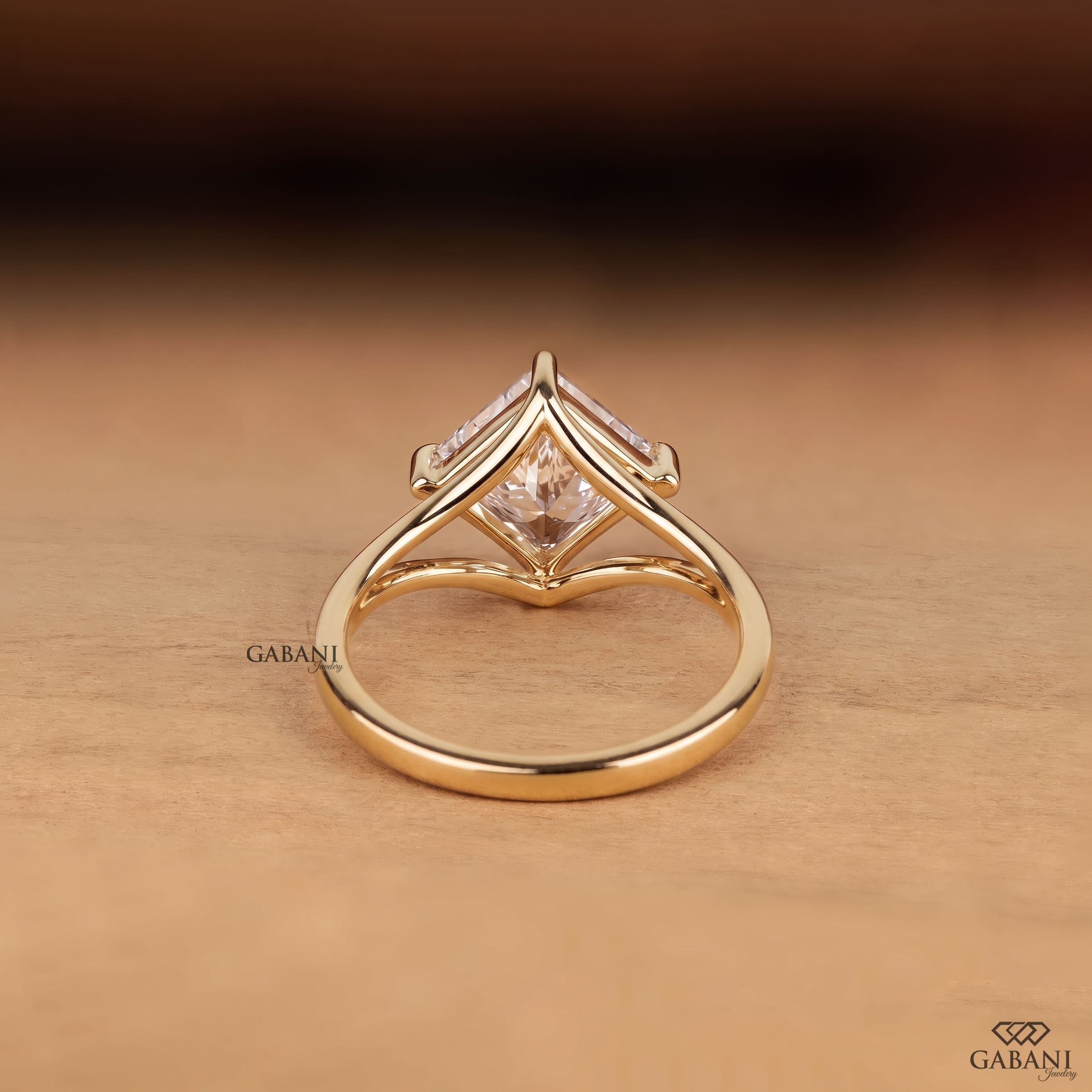 Princess cut lab grown diamond engagement ring in yellow gold featuring a kite set center stone, four prong setting, and modern open split shank design.